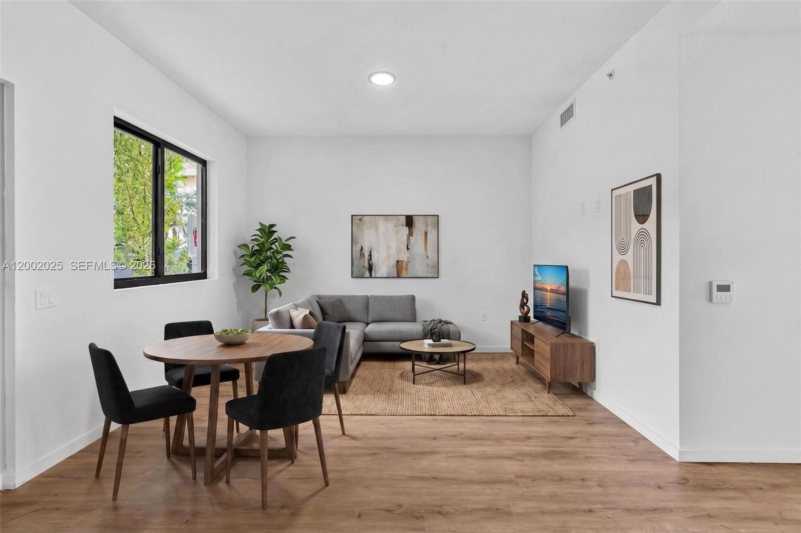 a dining room with furniture and window