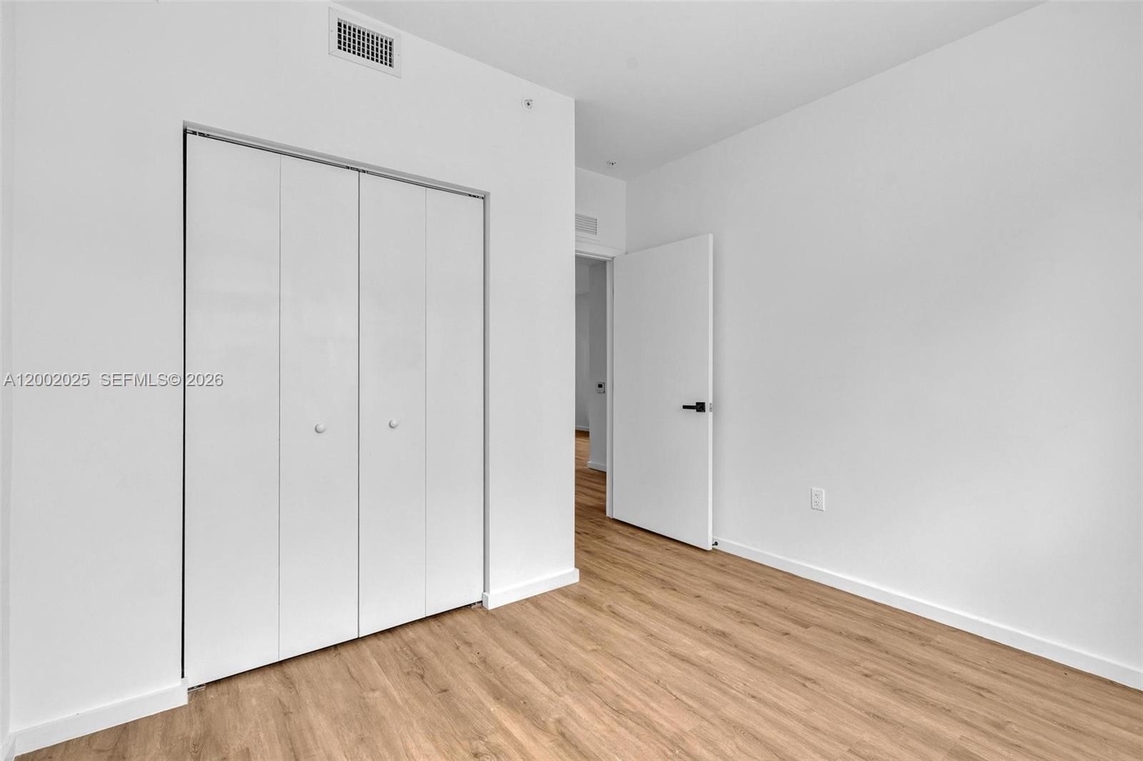 753 Northwest 30th Street, Unit 3 Miami, FL 33127 - Photo 11 of 35 a view of an empty room with wooden floor