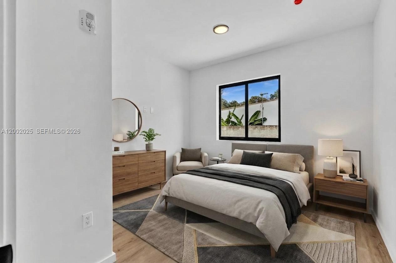 753 Northwest 30th Street, Unit 3 Miami, FL 33127 - Photo 12 of 35 a bedroom with a bed and a window