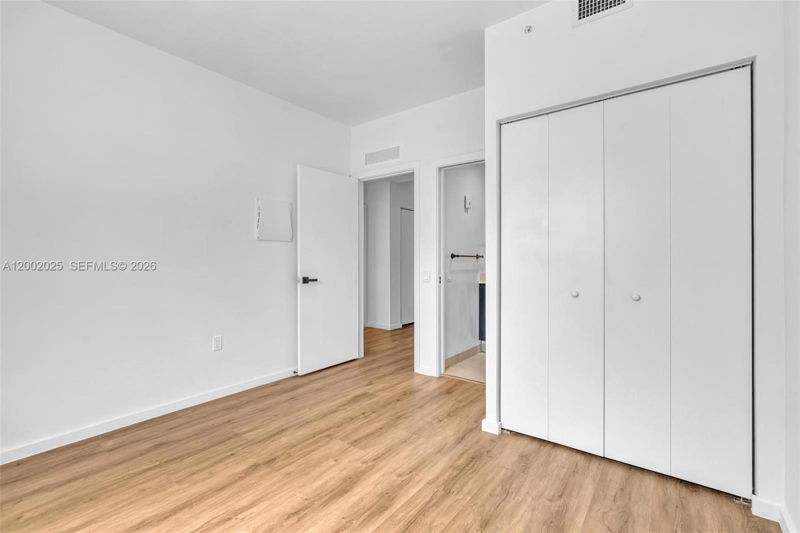 753 Northwest 30th Street, Unit 3 Miami, FL 33127 - Photo 14 of 35 a view of an empty room with wooden floor