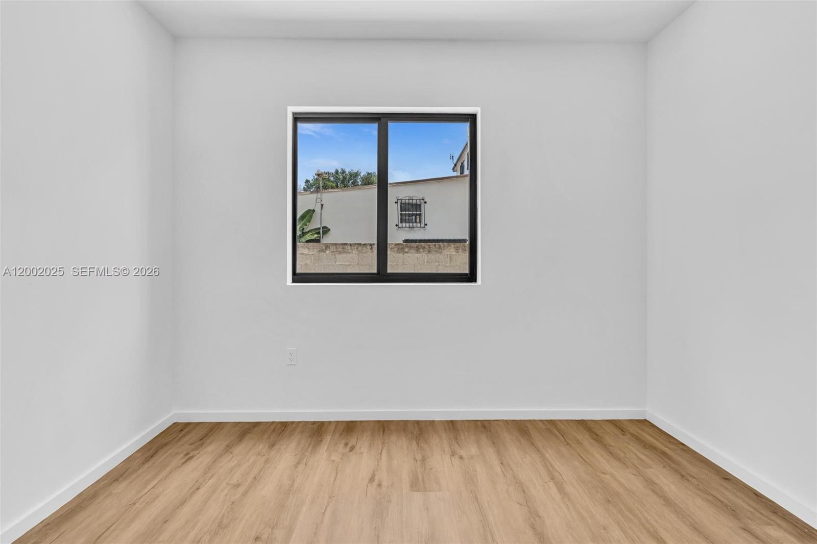 753 Northwest 30th Street, Unit 3 Miami, FL 33127 - Photo 15 of 35 a view of a small space with wooden floor and a window