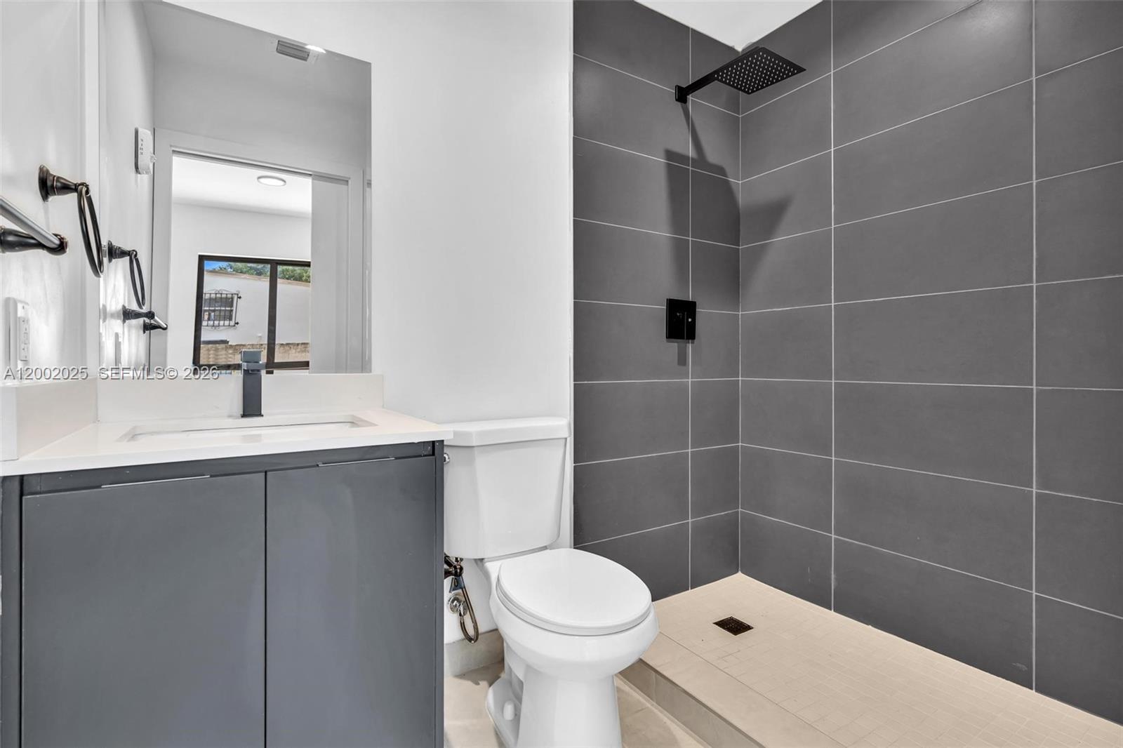 753 Northwest 30th Street, Unit 3 Miami, FL 33127 - Photo 16 of 35 a bathroom with a sink toilet and shower