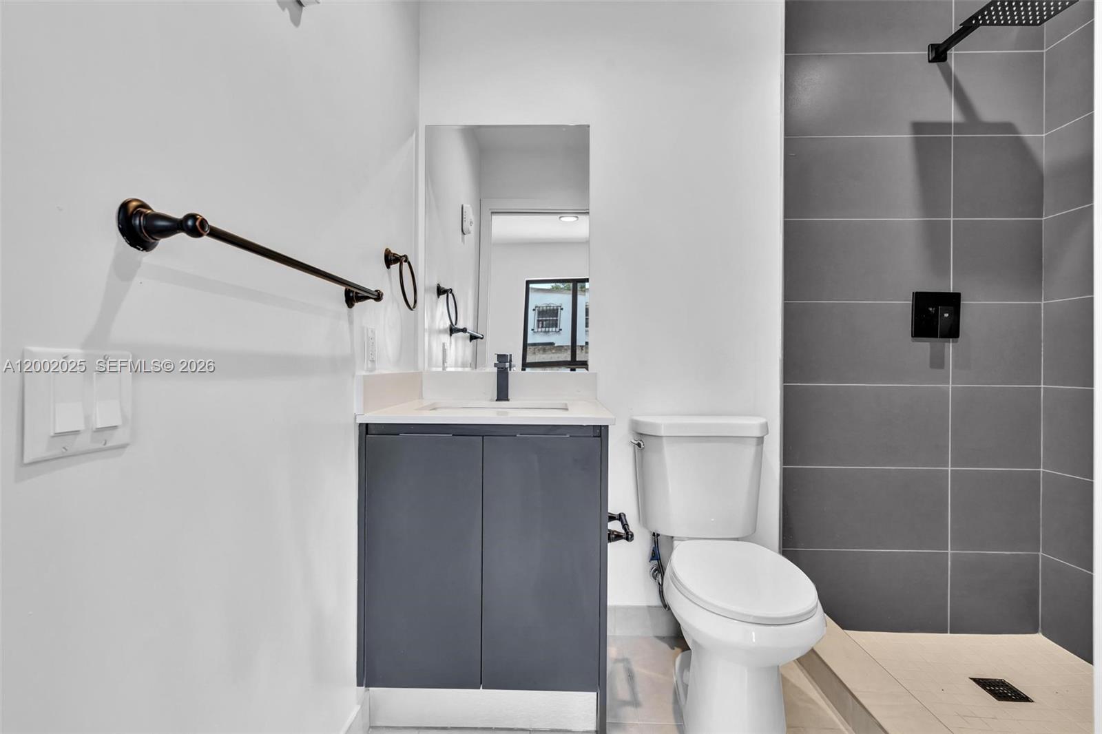 753 Northwest 30th Street, Unit 3 Miami, FL 33127 - Photo 17 of 35 a bathroom with a sink a toilet and shower