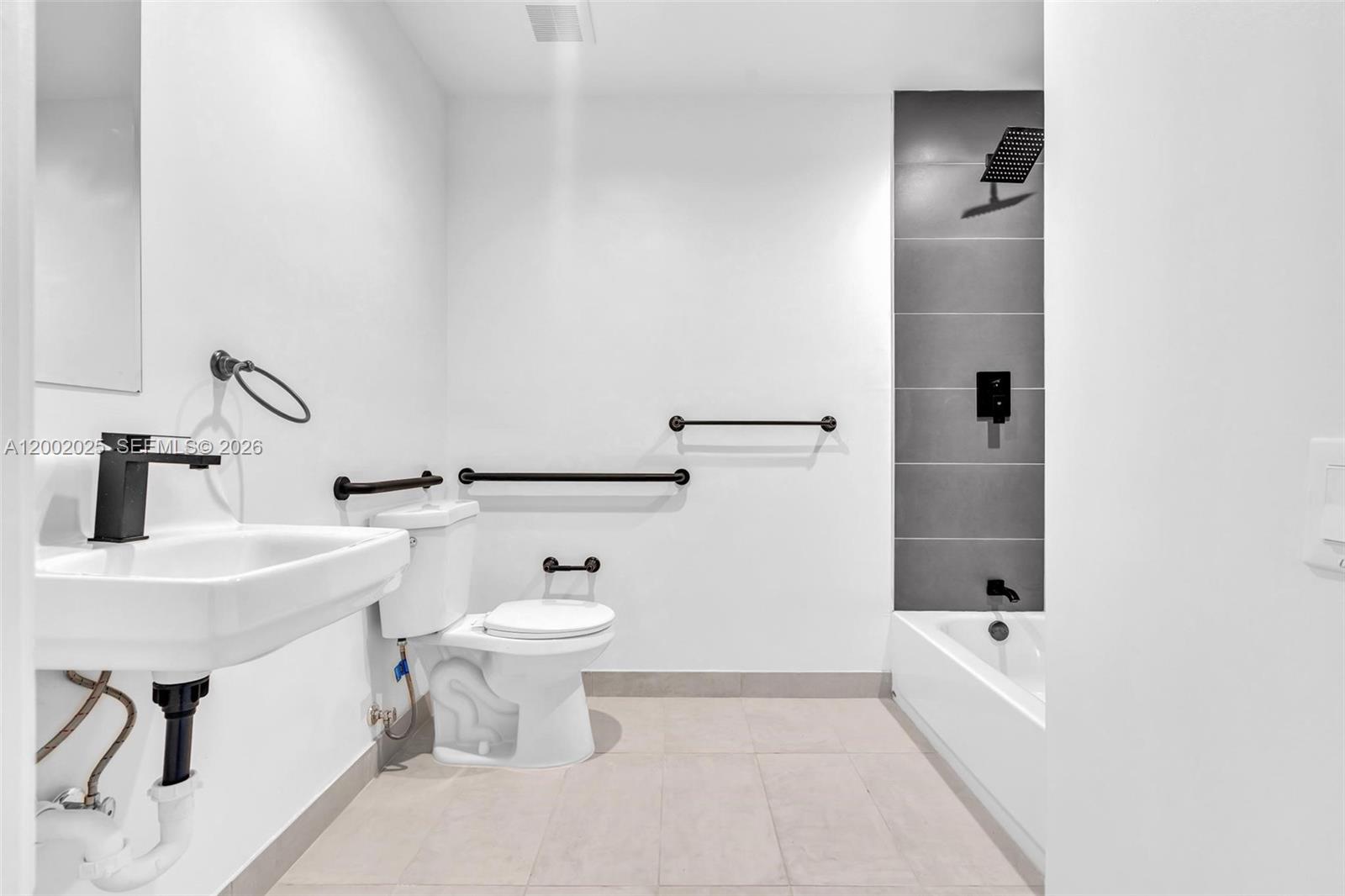 753 Northwest 30th Street, Unit 3 Miami, FL 33127 - Photo 18 of 35 a bathroom with a sink a toilet and shower