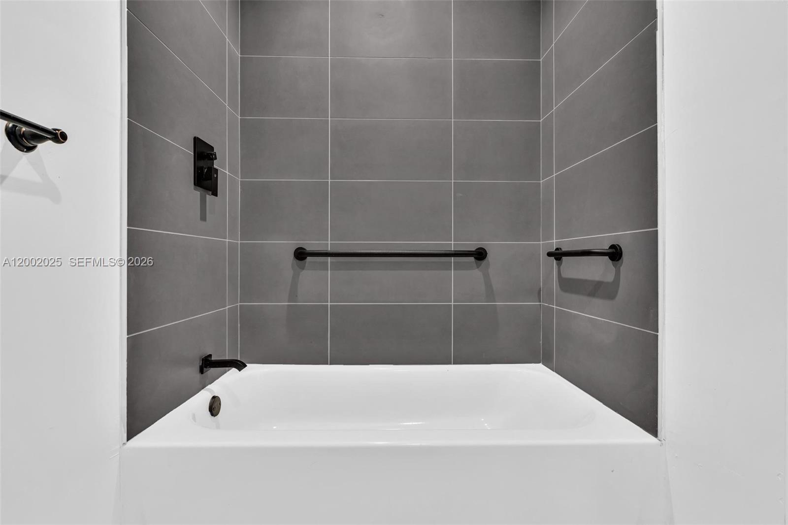 753 Northwest 30th Street, Unit 3 Miami, FL 33127 - Photo 19 of 35 a bathroom with a bath tub