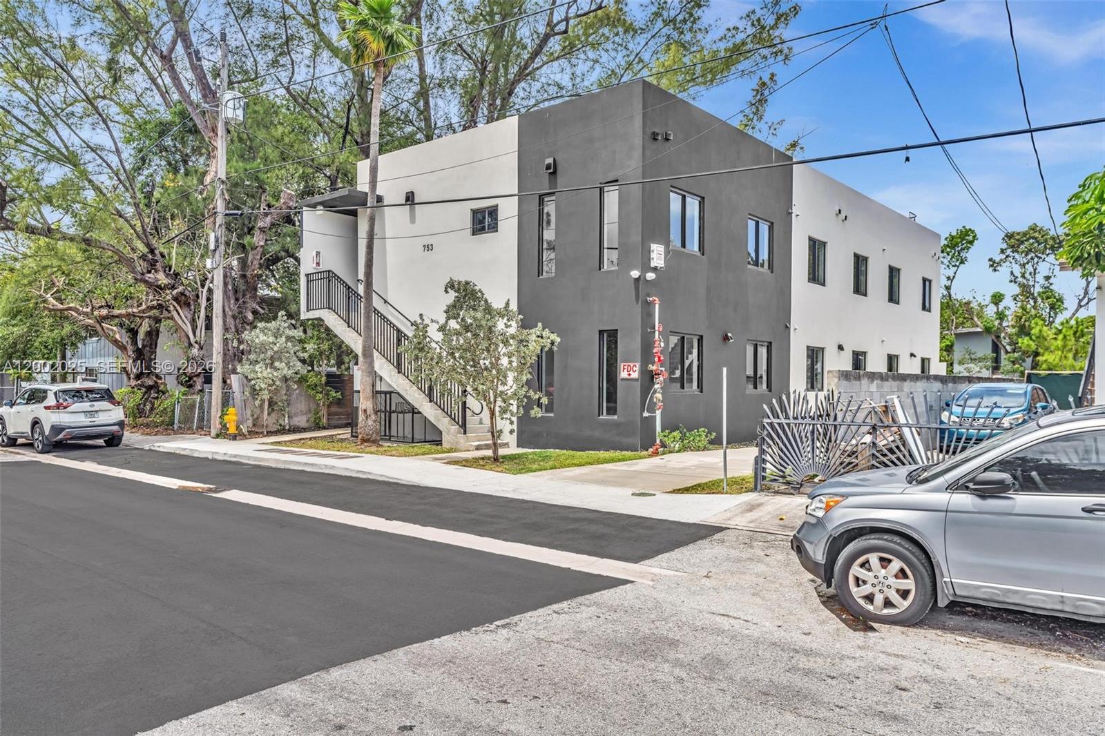 753 Northwest 30th Street, Unit 3 Miami, FL 33127 - Photo 25 of 35 a front view of a house with parking area