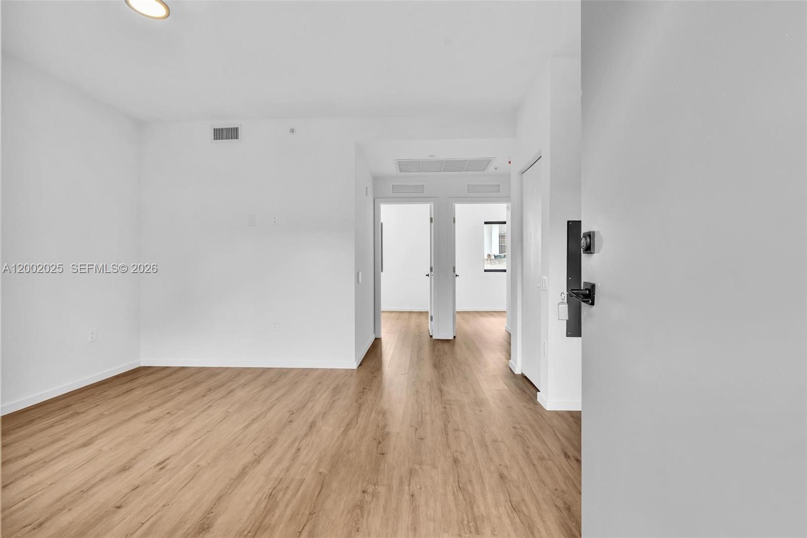 753 Northwest 30th Street, Unit 3 Miami, FL 33127 - Photo 30 of 35 a view of a hallway with wooden floor