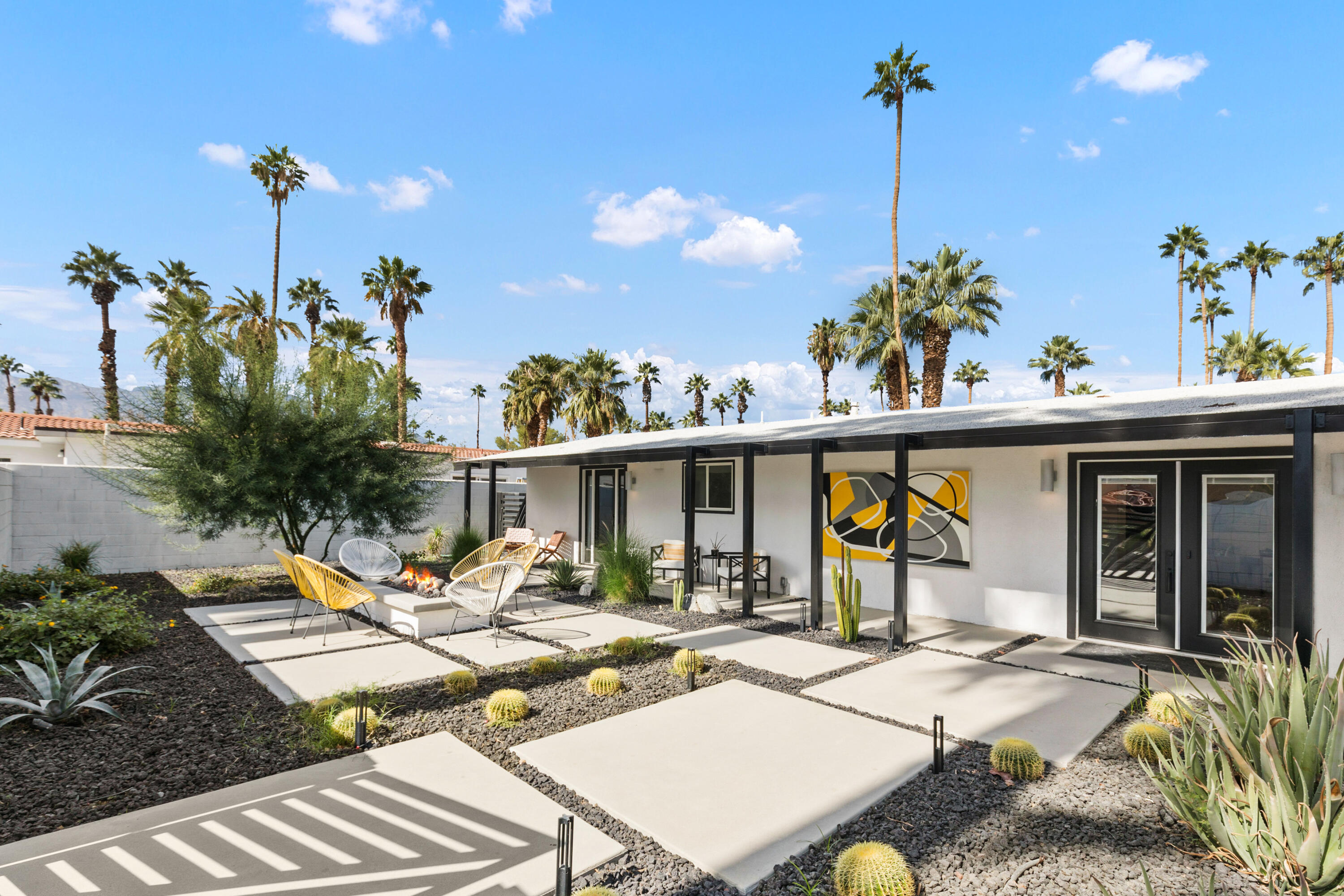 70050 Chappel Road Rancho Mirage, CA 92270 - Photo 1 of 36 a view of a patio with table and chairs potted plants and wooden floor