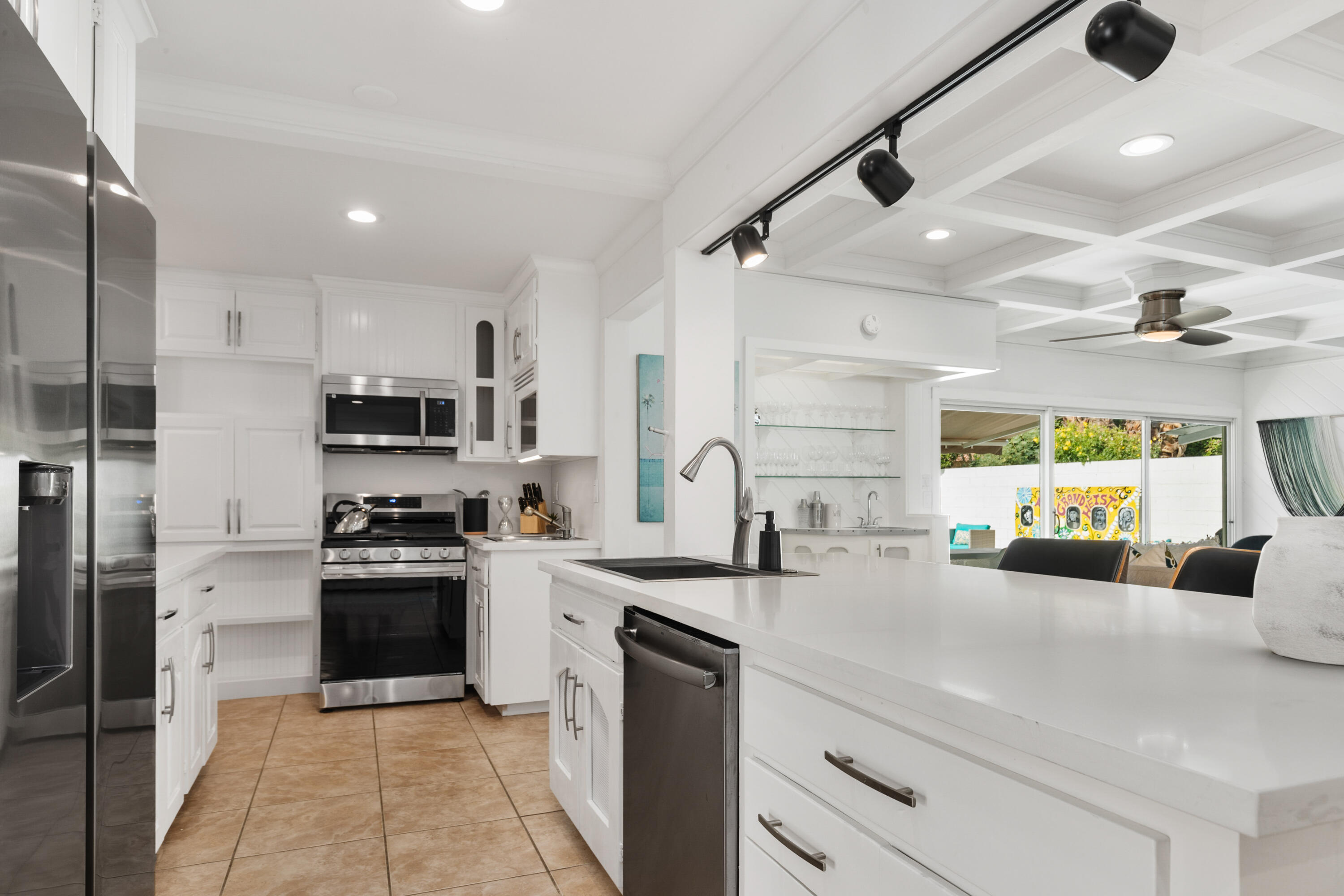70050 Chappel Road Rancho Mirage, CA 92270 - Photo 19 of 36 a kitchen with stainless steel appliances granite countertop a sink a stove and a refrigerator