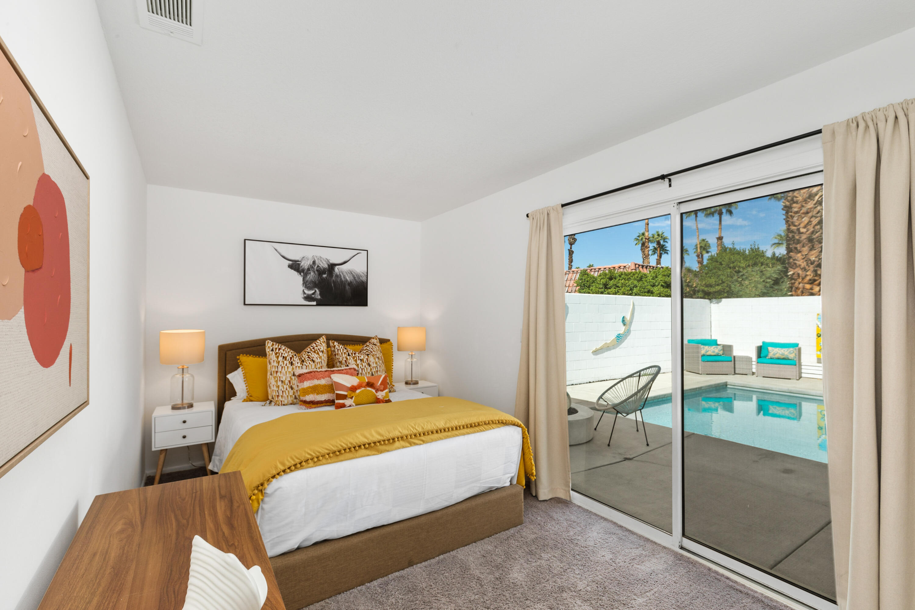 70050 Chappel Road Rancho Mirage, CA 92270 - Photo 22 of 36 a bedroom with a bed and glass door