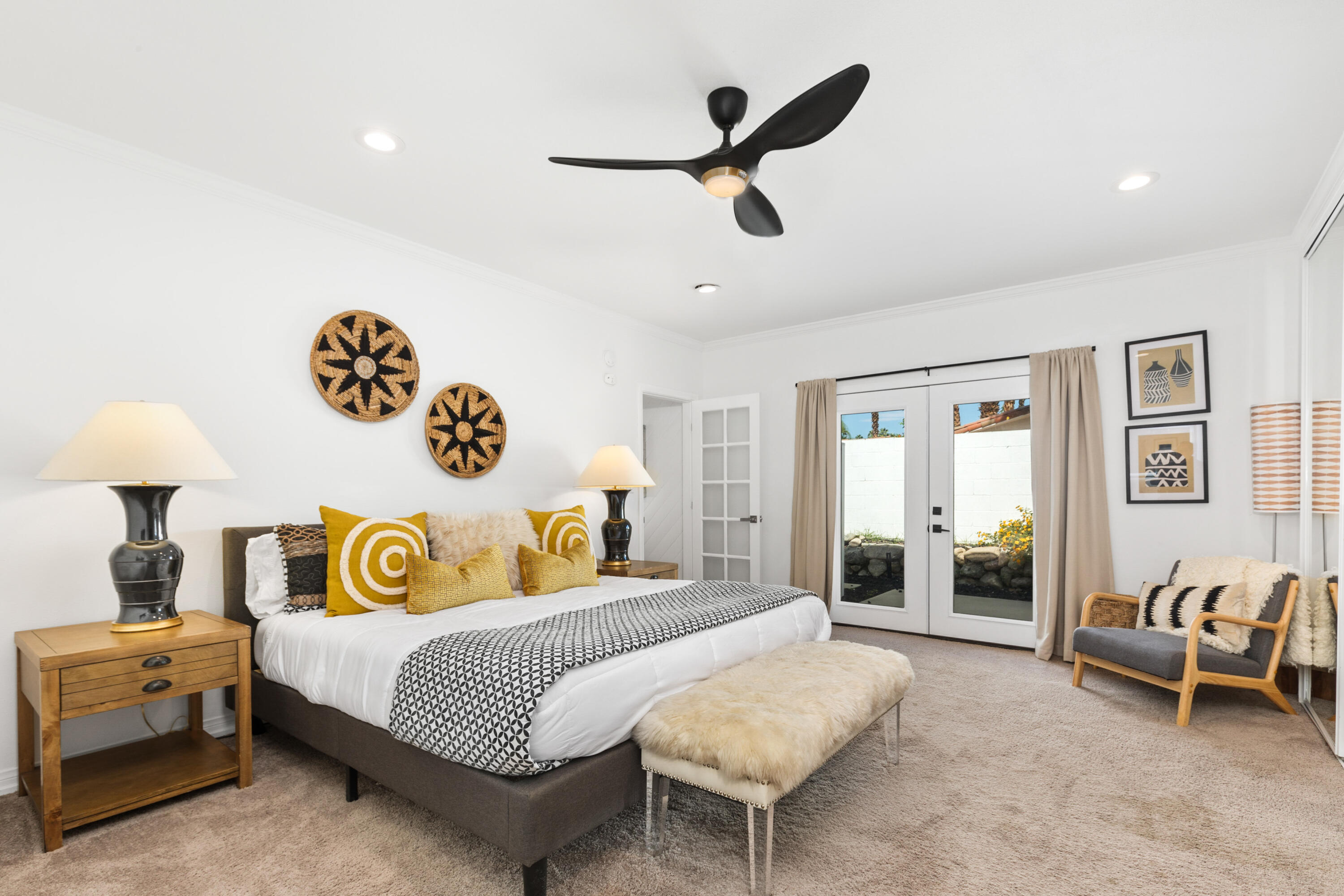 70050 Chappel Road Rancho Mirage, CA 92270 - Photo 27 of 36 a bedroom with a bed and a chandelier