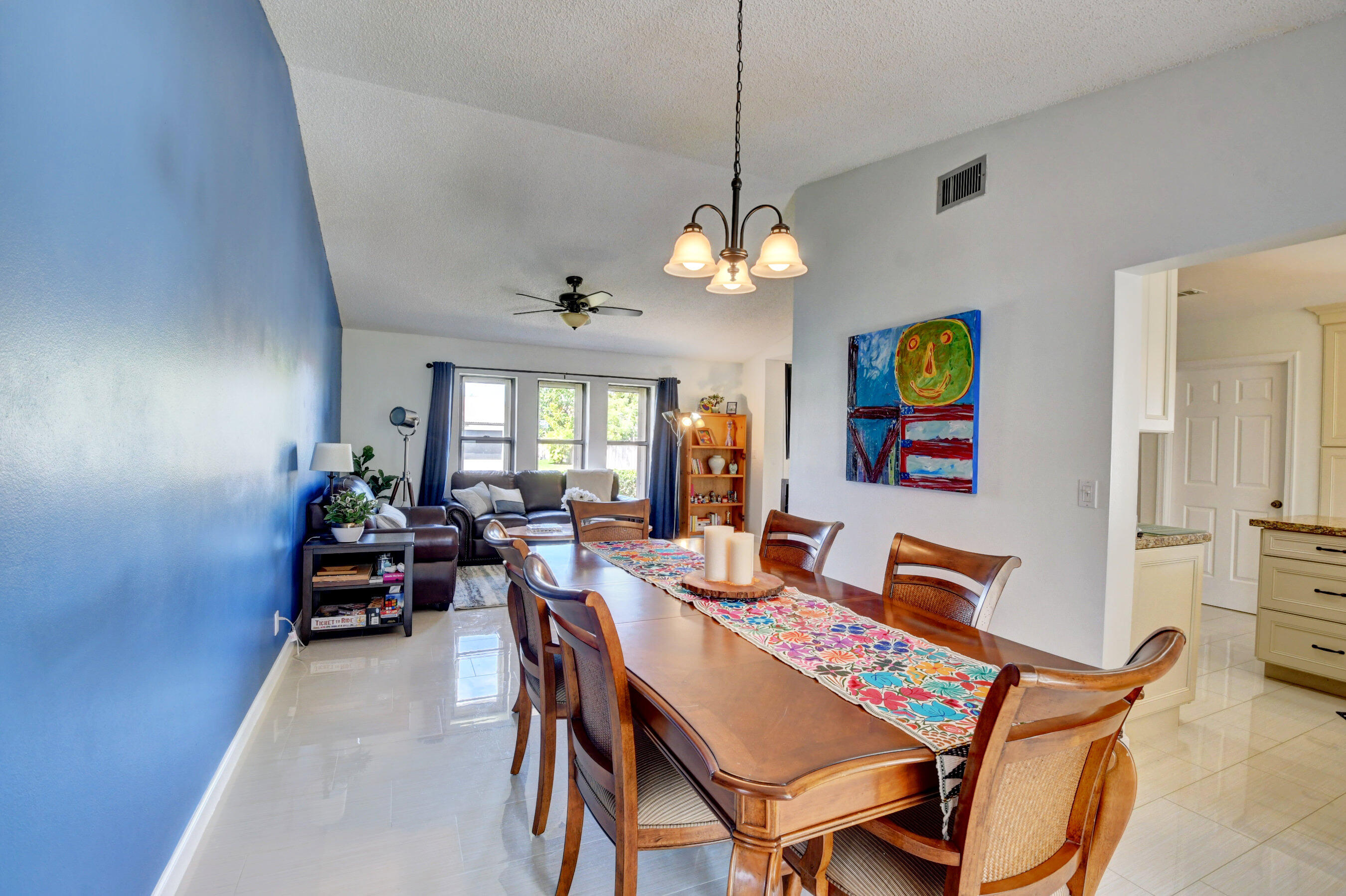 4192 Woods End Road Boca Raton, FL 33487 - Photo 14 of 63 a view of a dining room with furniture a chandelier and wooden floor