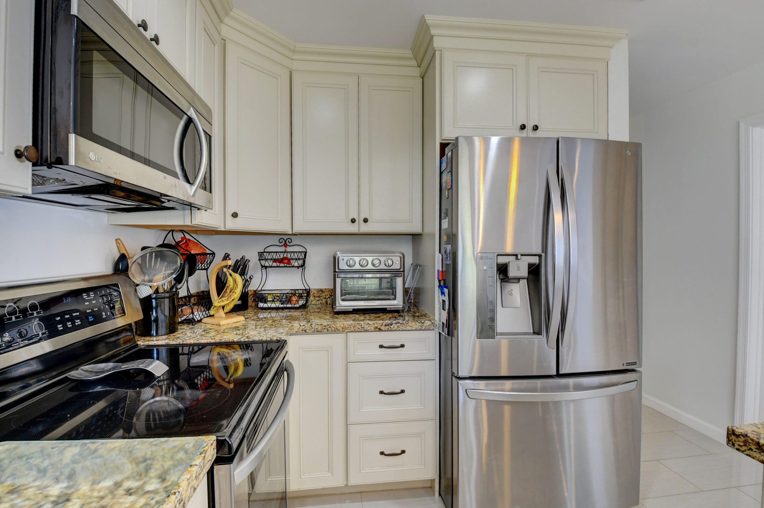 4192 Woods End Road Boca Raton, FL 33487 - Photo 15 of 63 a kitchen with stainless steel appliances granite countertop a refrigerator and a stove top oven