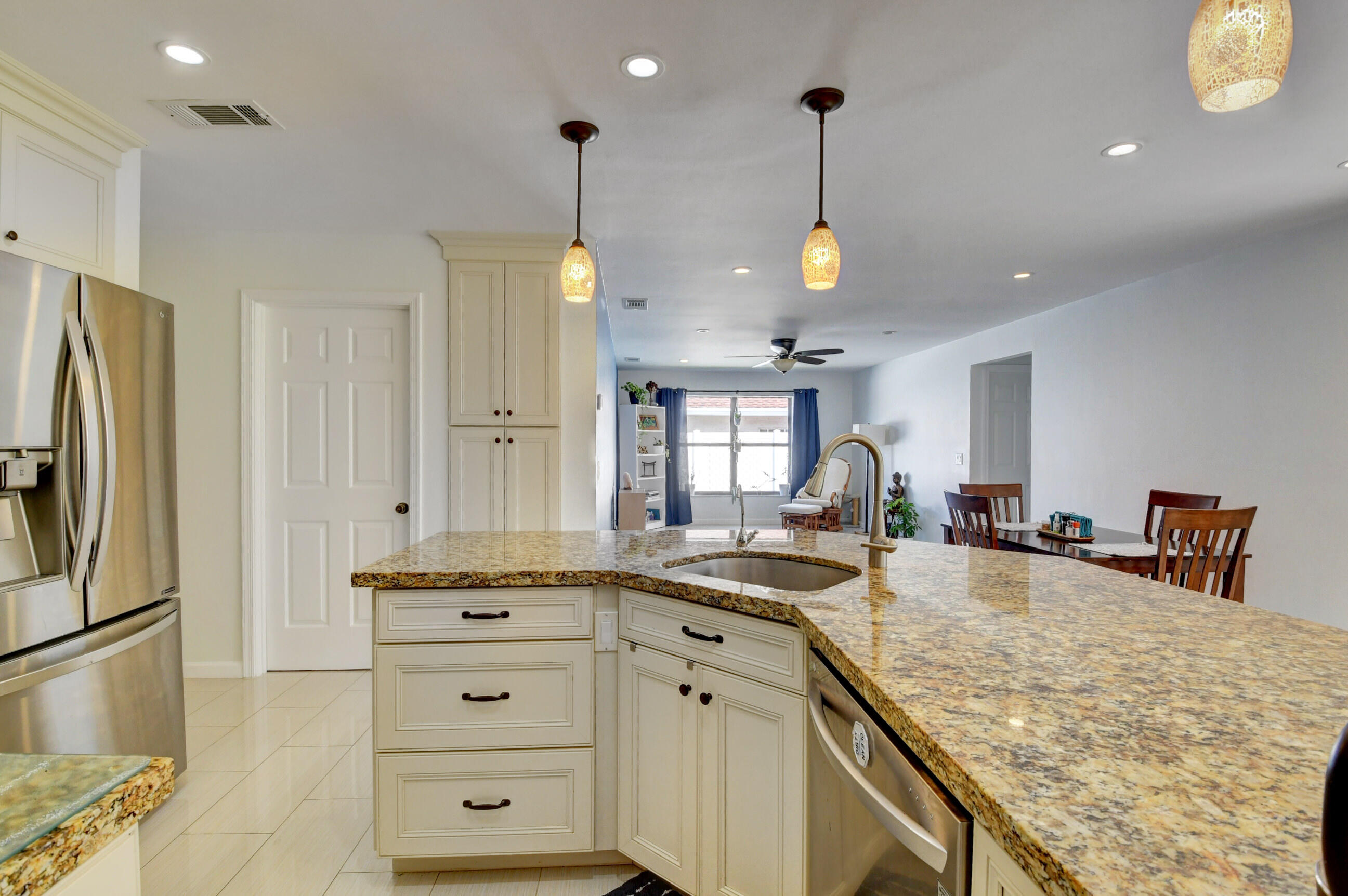 4192 Woods End Road Boca Raton, FL 33487 - Photo 16 of 63 a kitchen with stainless steel appliances granite countertop a sink a stove and a refrigerator