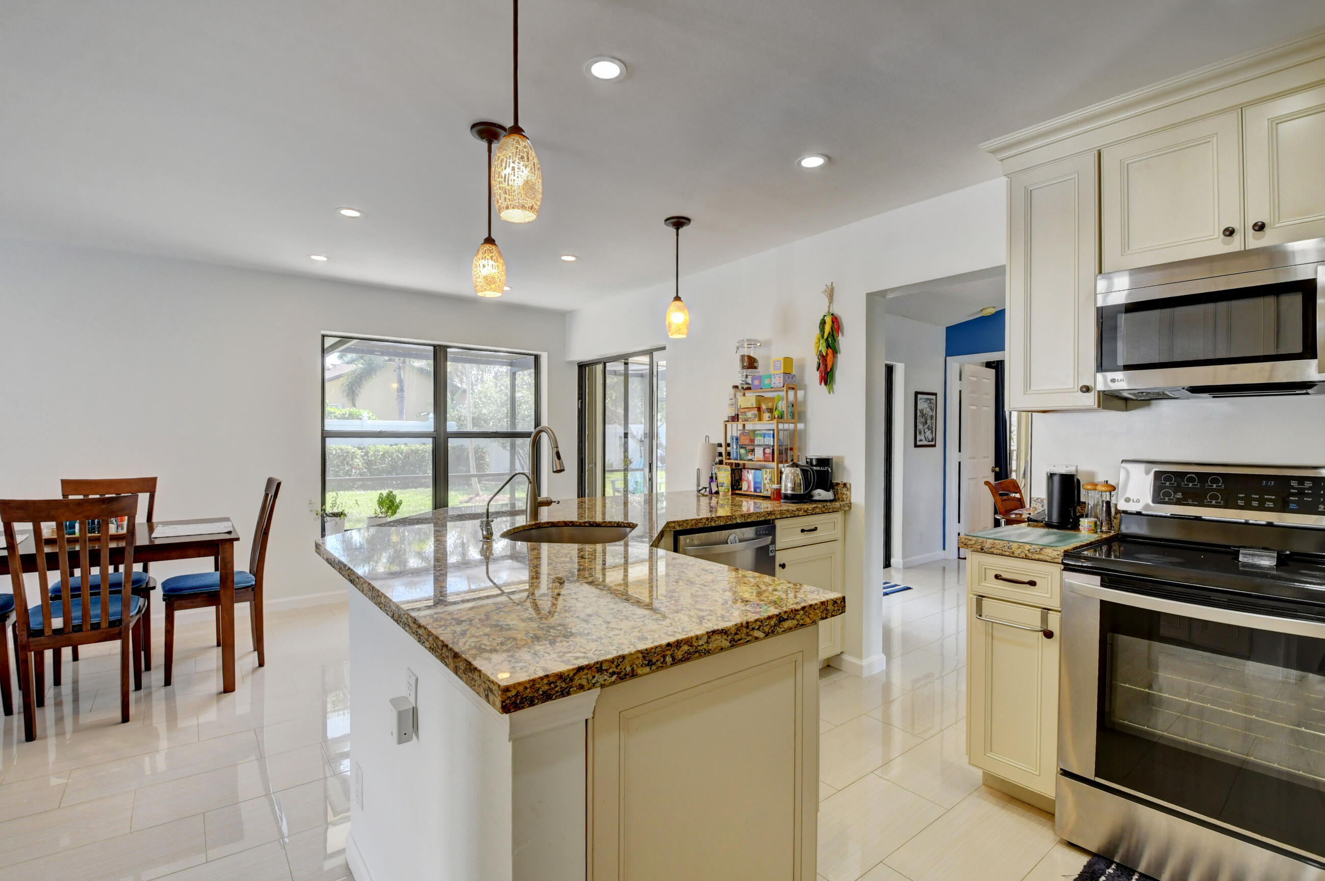 4192 Woods End Road Boca Raton, FL 33487 - Photo 17 of 63 a kitchen with stainless steel appliances granite countertop a stove and a refrigerator