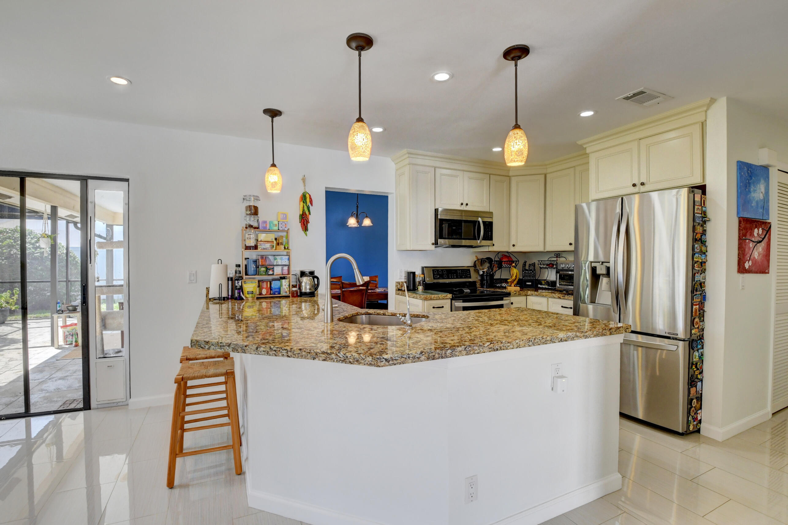 4192 Woods End Road Boca Raton, FL 33487 - Photo 18 of 63 a kitchen with refrigerator and microwave