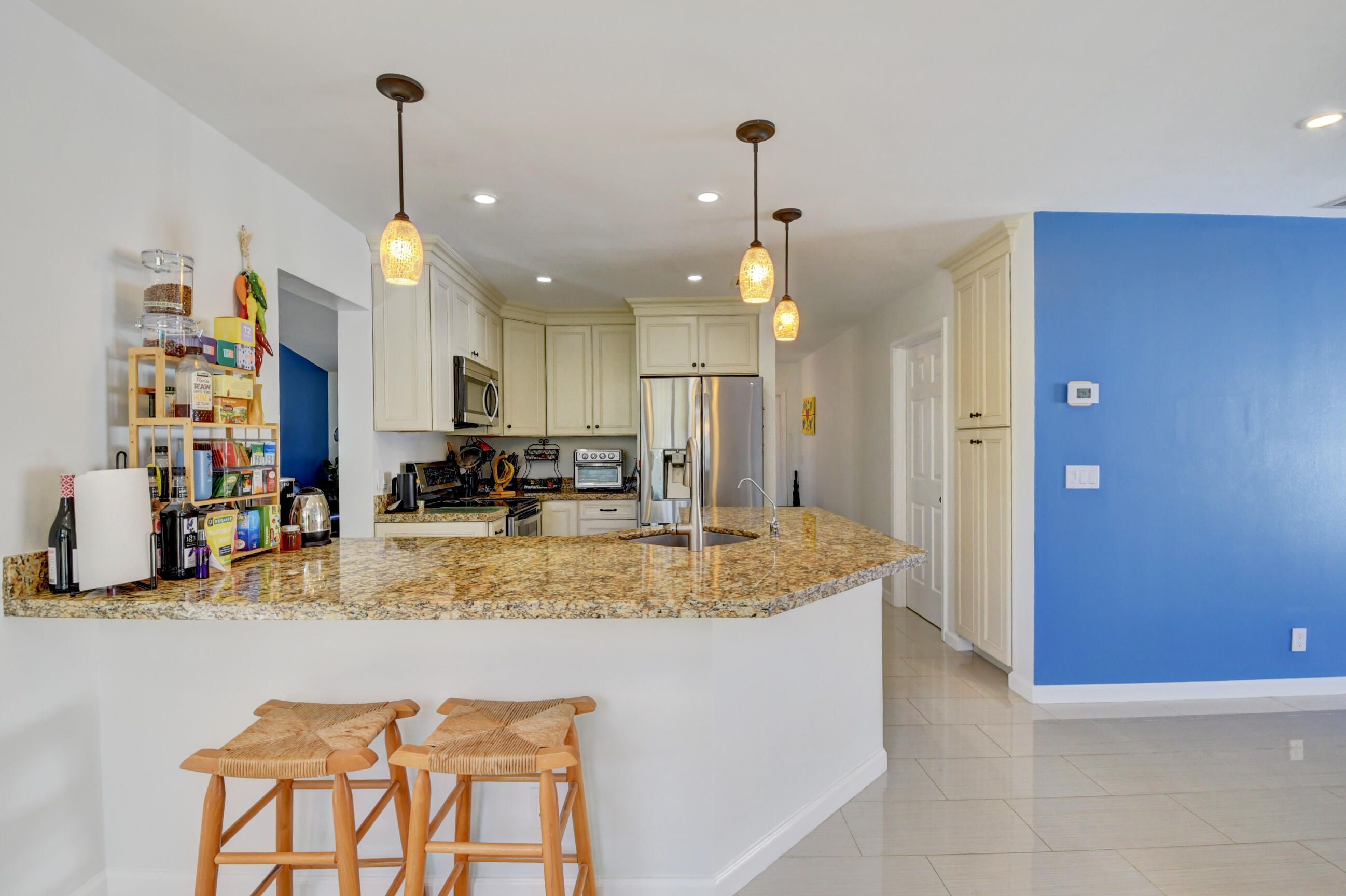 4192 Woods End Road Boca Raton, FL 33487 - Photo 19 of 63 a view of a kitchen with kitchen island a counter top space appliances and cabinets