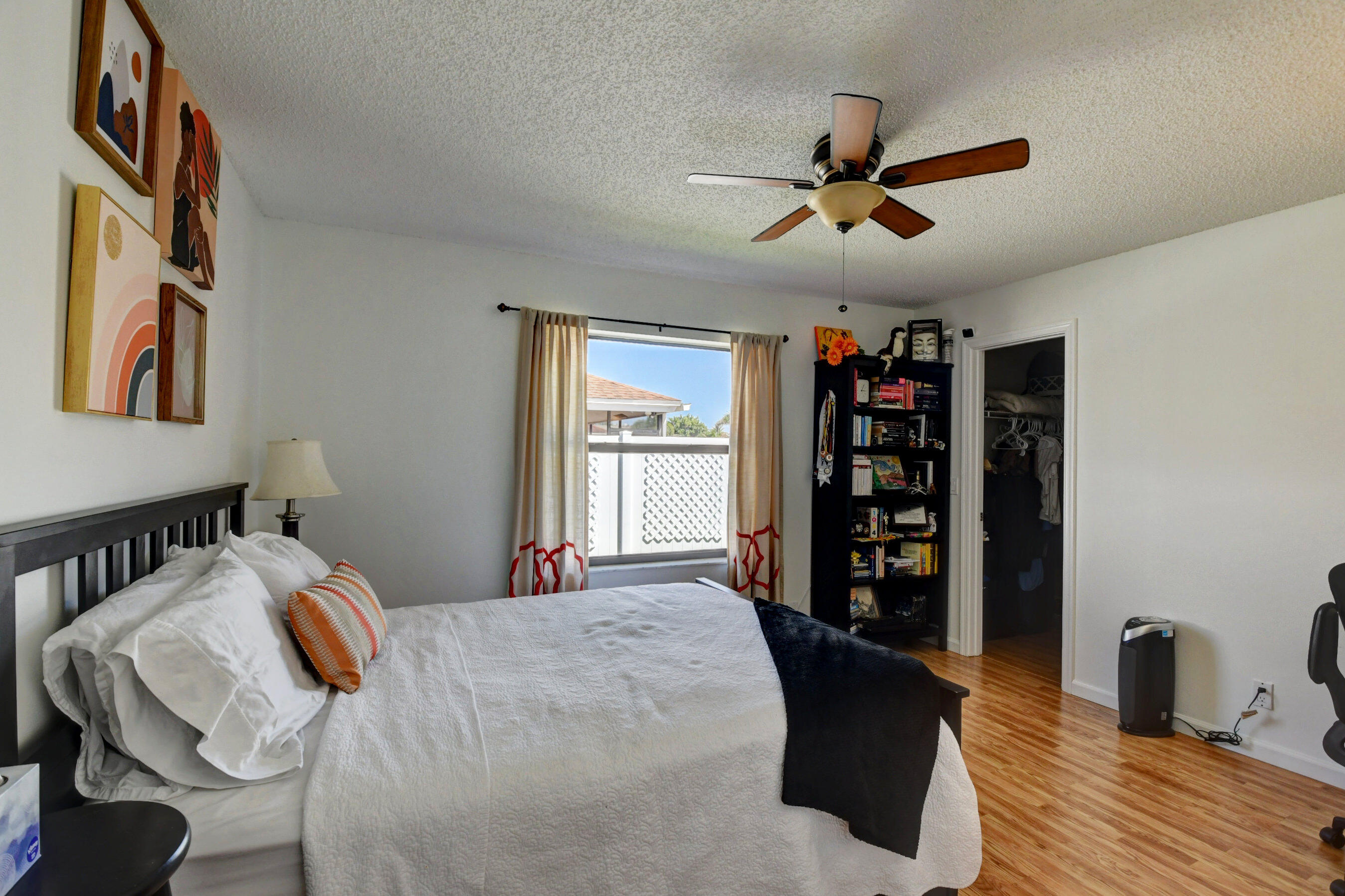 4192 Woods End Road Boca Raton, FL 33487 - Photo 25 of 63 a bedroom with a bed and a book shelf