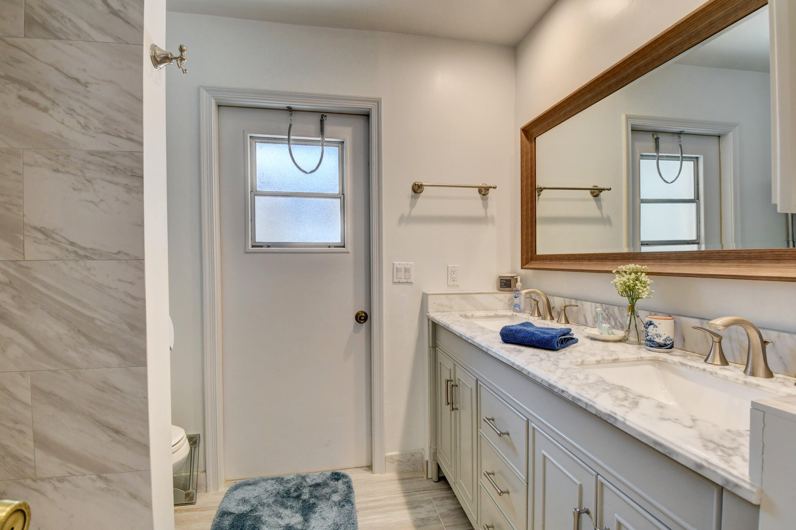 4192 Woods End Road Boca Raton, FL 33487 - Photo 27 of 63 a bathroom with a granite countertop sink and a mirror