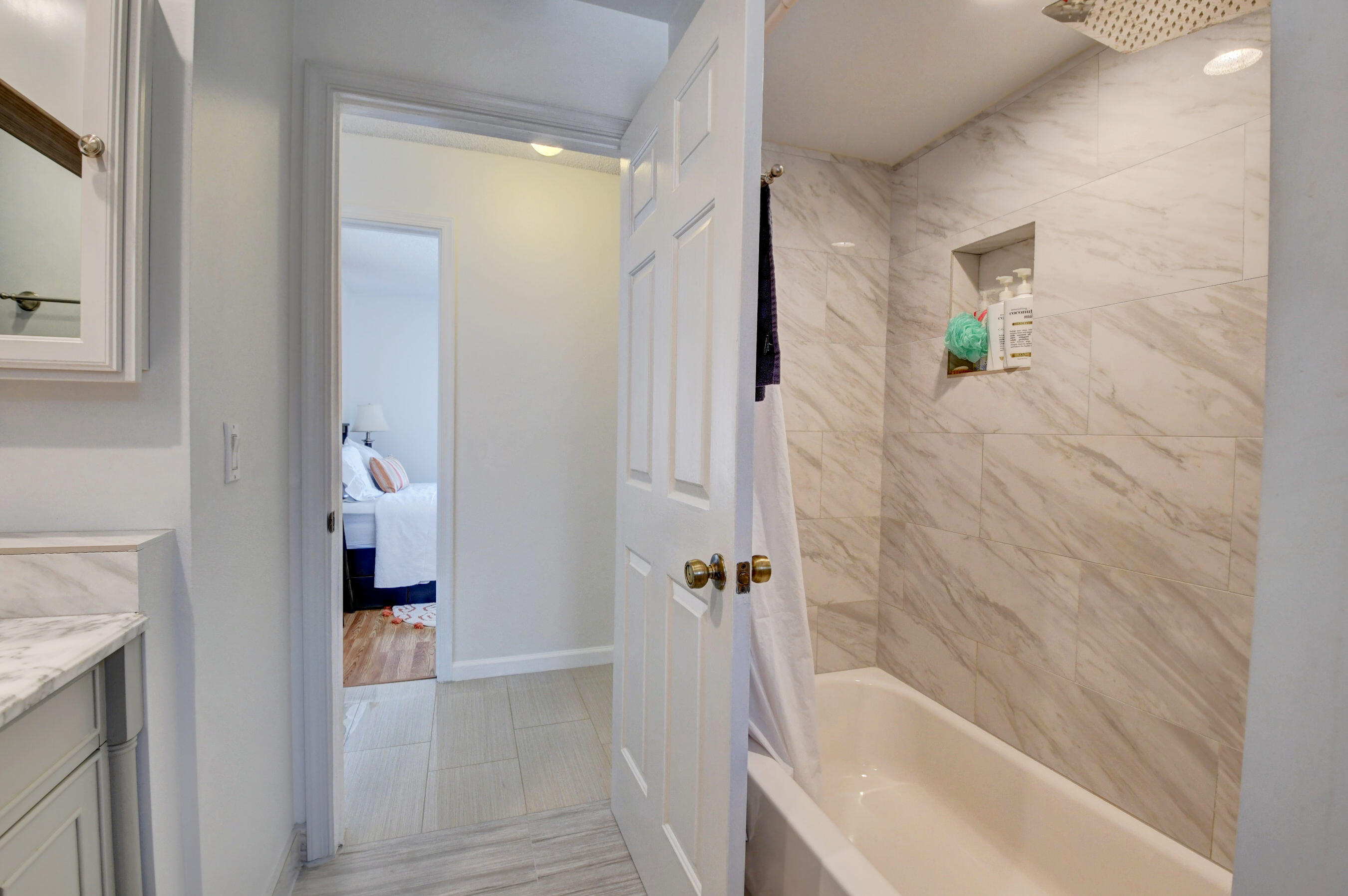 4192 Woods End Road Boca Raton, FL 33487 - Photo 28 of 63 a bathroom with a bathtub and a shower
