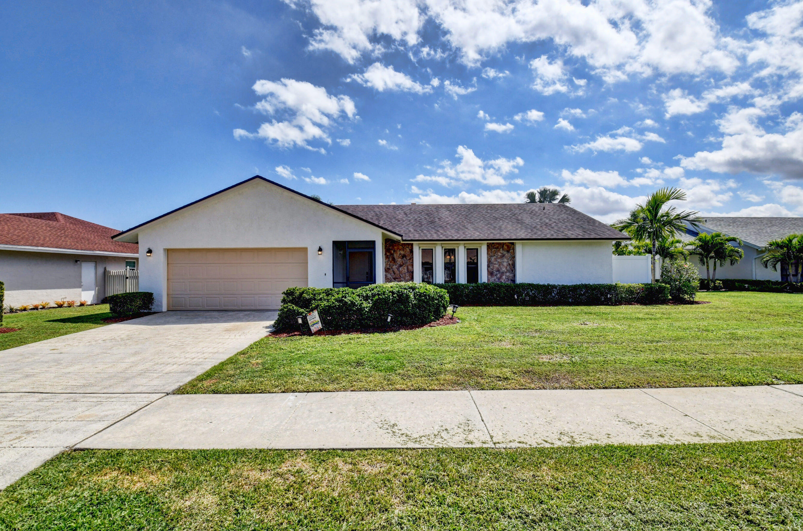 4192 Woods End Road Boca Raton, FL 33487 - Photo 3 of 63 a front view of a house with a yard and garage