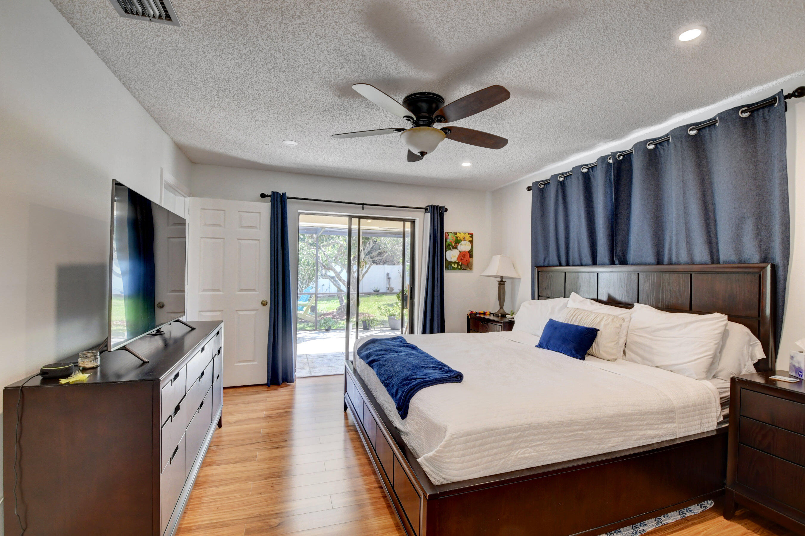 4192 Woods End Road Boca Raton, FL 33487 - Photo 32 of 63 a bedroom with a bed and a flat tv screen on dresser