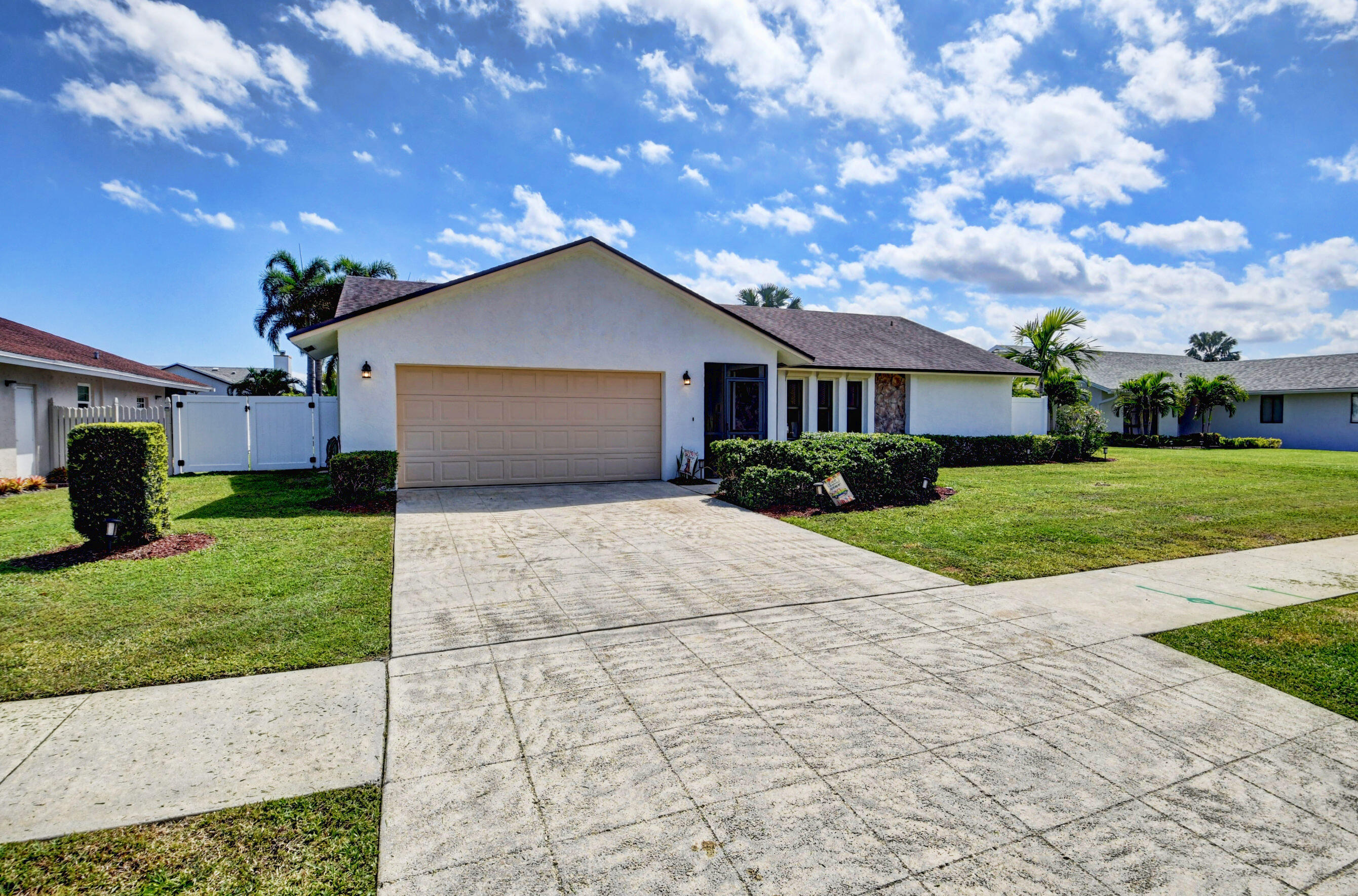 4192 Woods End Road Boca Raton, FL 33487 - Photo 4 of 63 a front view of house with yard and green space