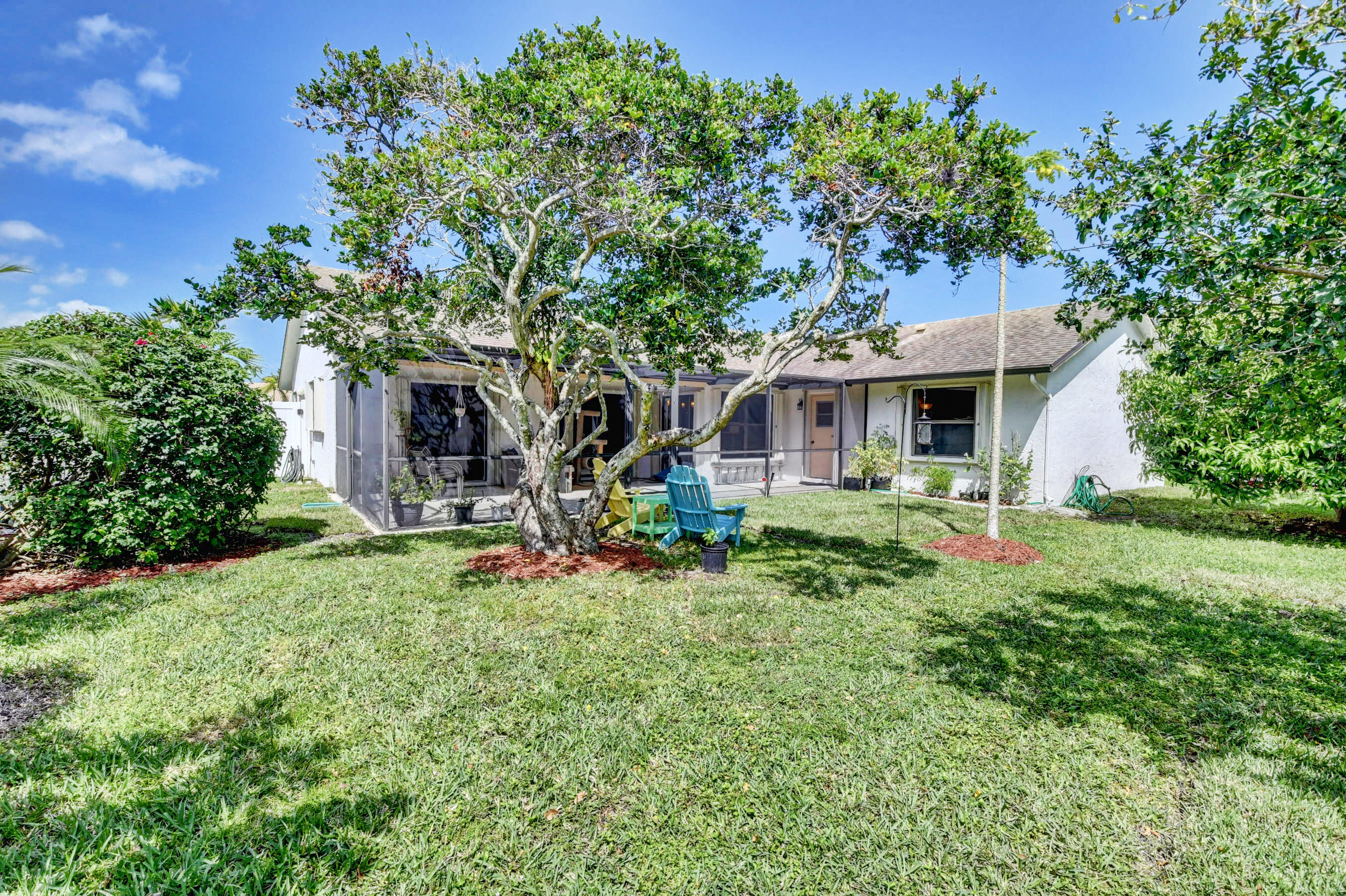 4192 Woods End Road Boca Raton, FL 33487 - Photo 45 of 63 a front view of a house with a yard