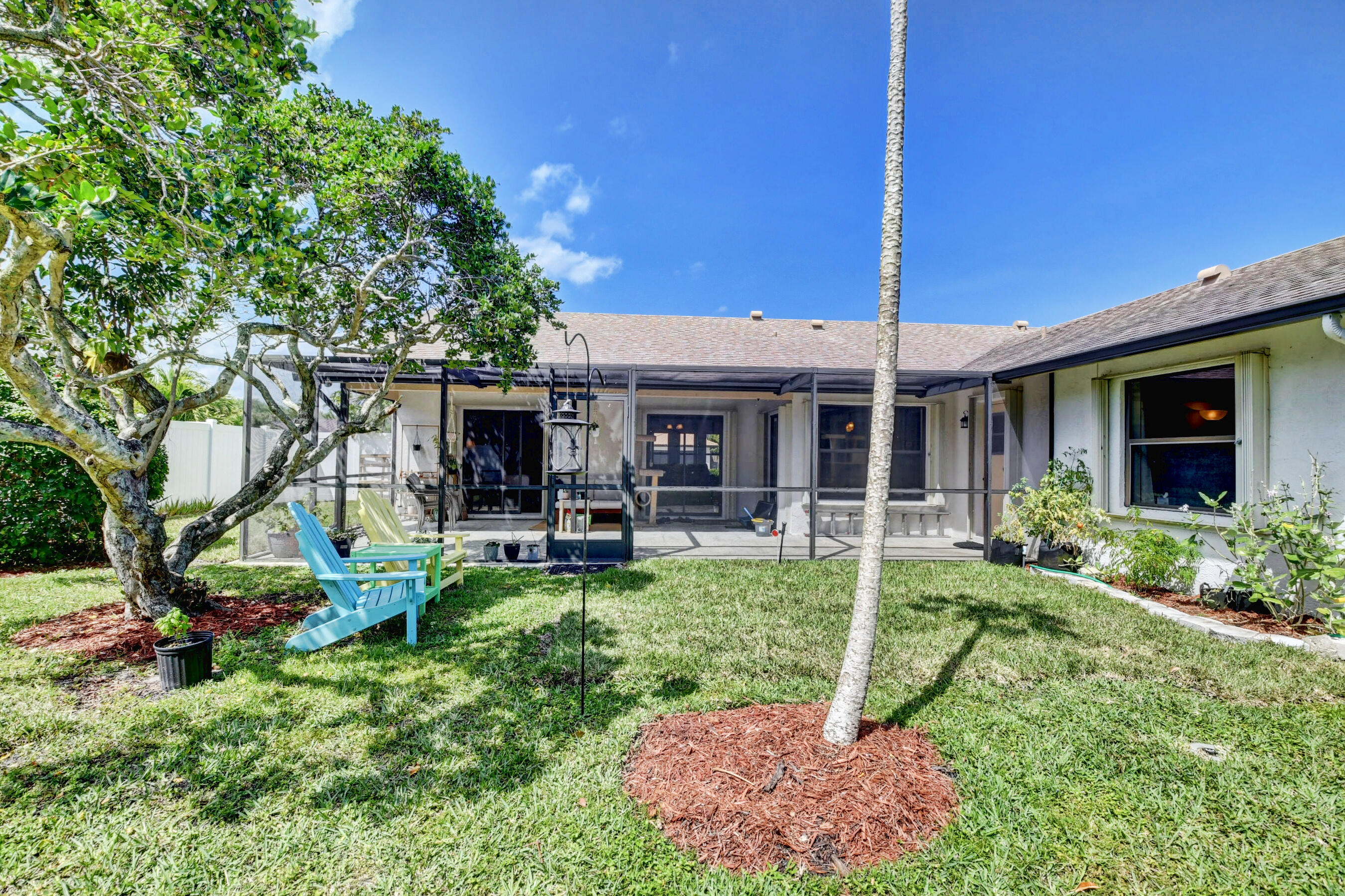 4192 Woods End Road Boca Raton, FL 33487 - Photo 46 of 63 a view of a house with backyard sitting area and garden