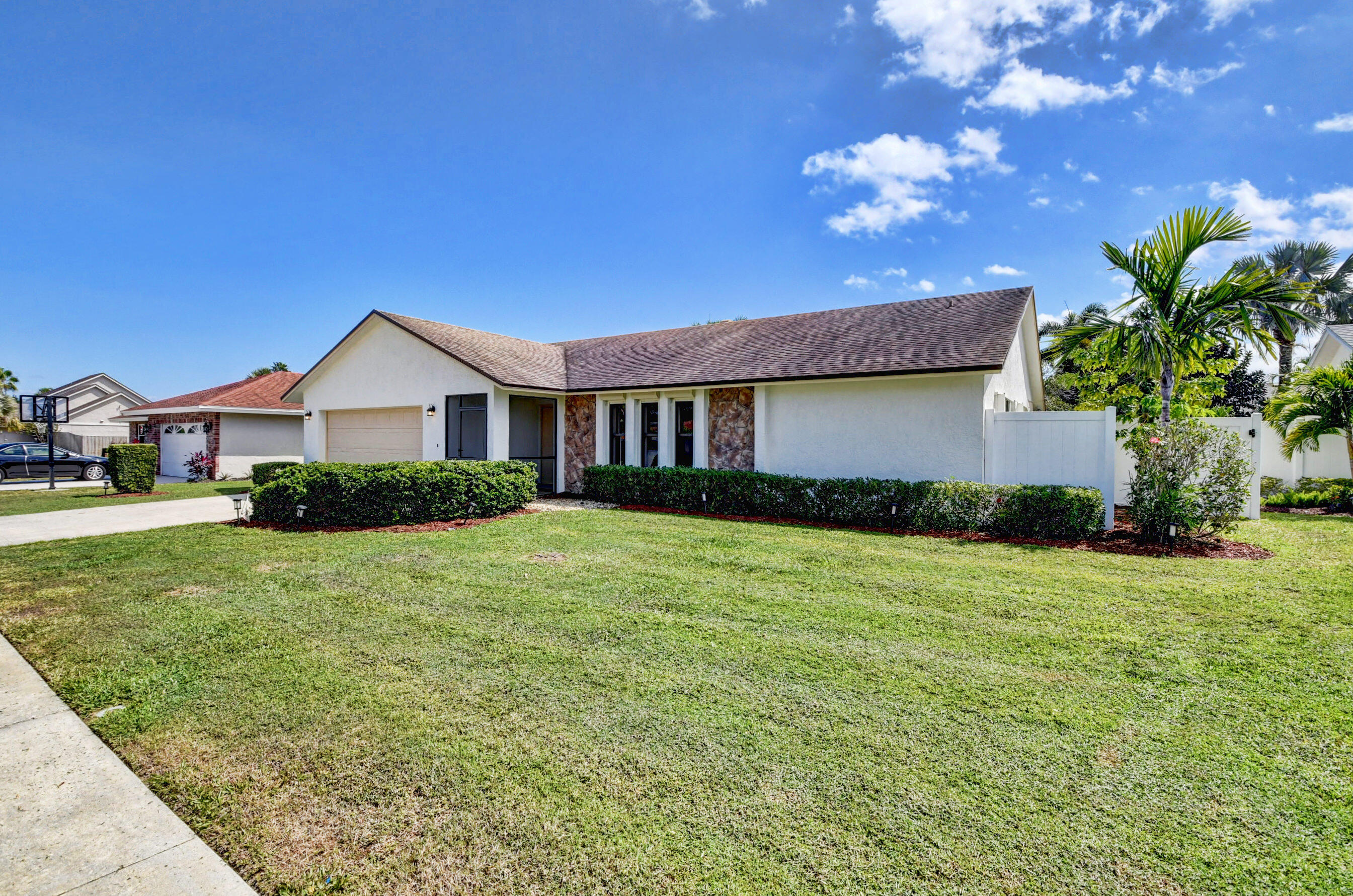 4192 Woods End Road Boca Raton, FL 33487 - Photo 5 of 63 a front view of a house with a yard