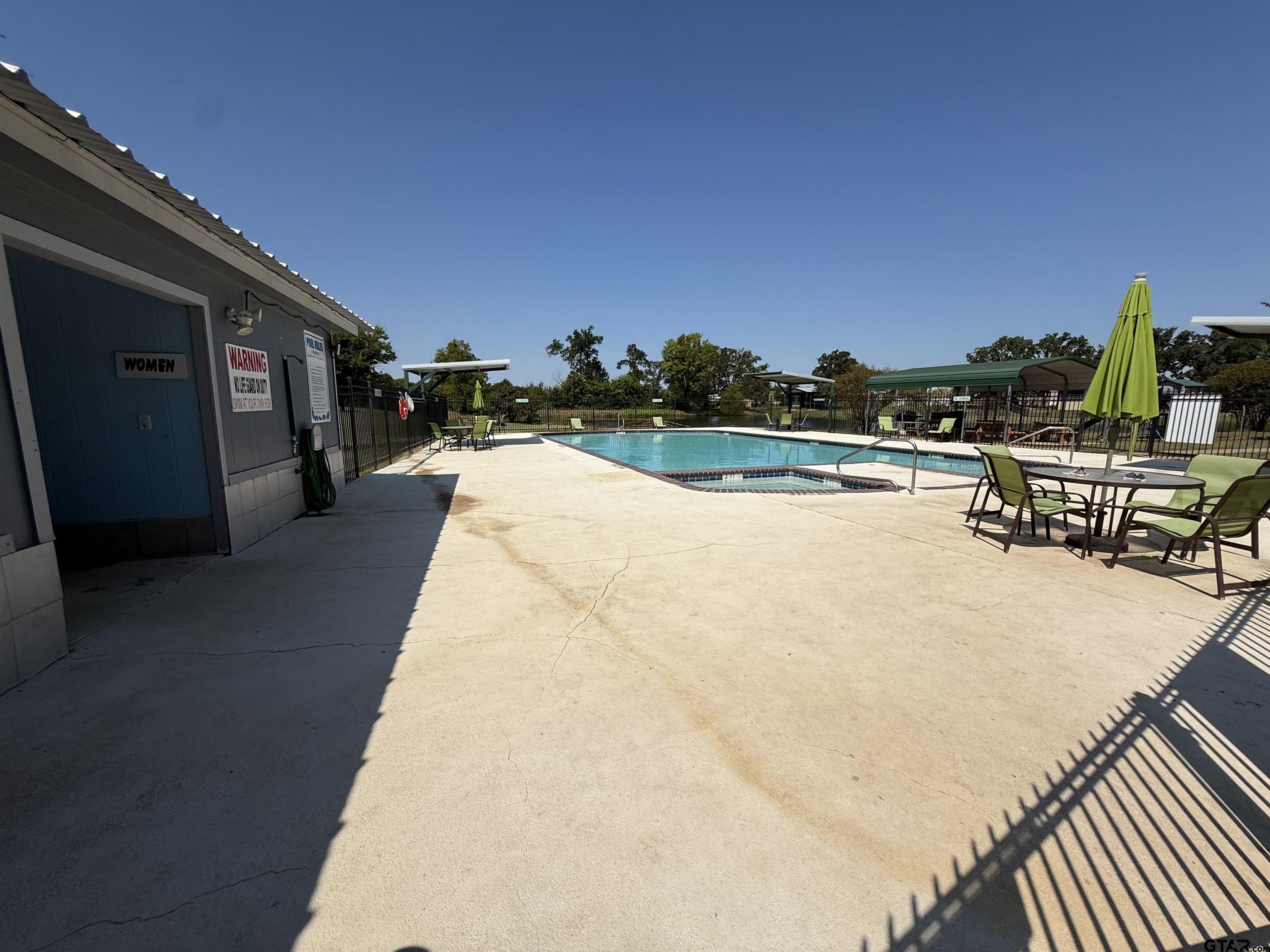 0 Waterfront Row, Unit 213 Quitman, TX 75783 - Photo 13 of 24 a view of a swimming pool with a lounge chair
