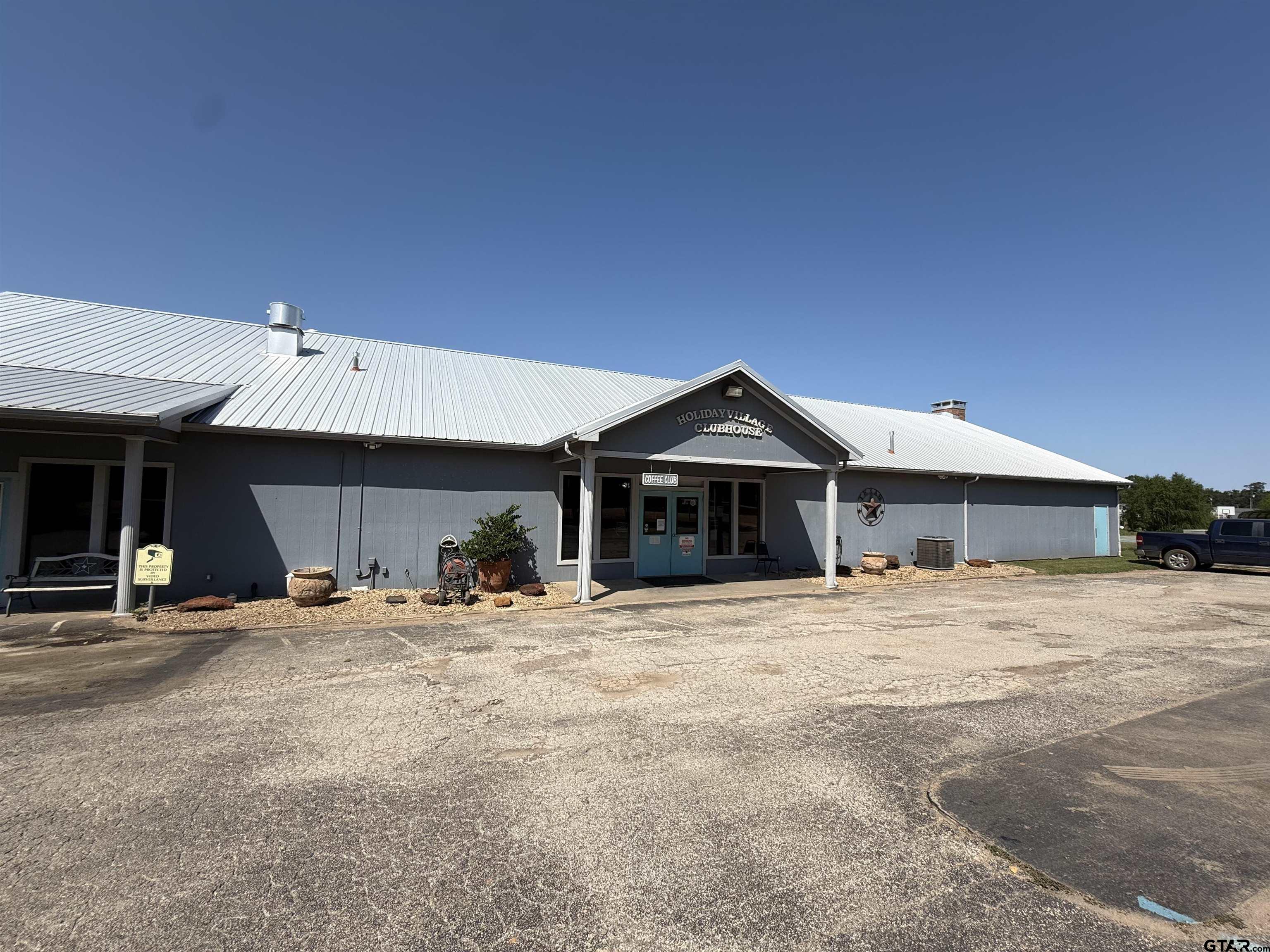 0 Waterfront Row, Unit 213 Quitman, TX 75783 - Photo 15 of 24 a front view of a house with two trees in front of it