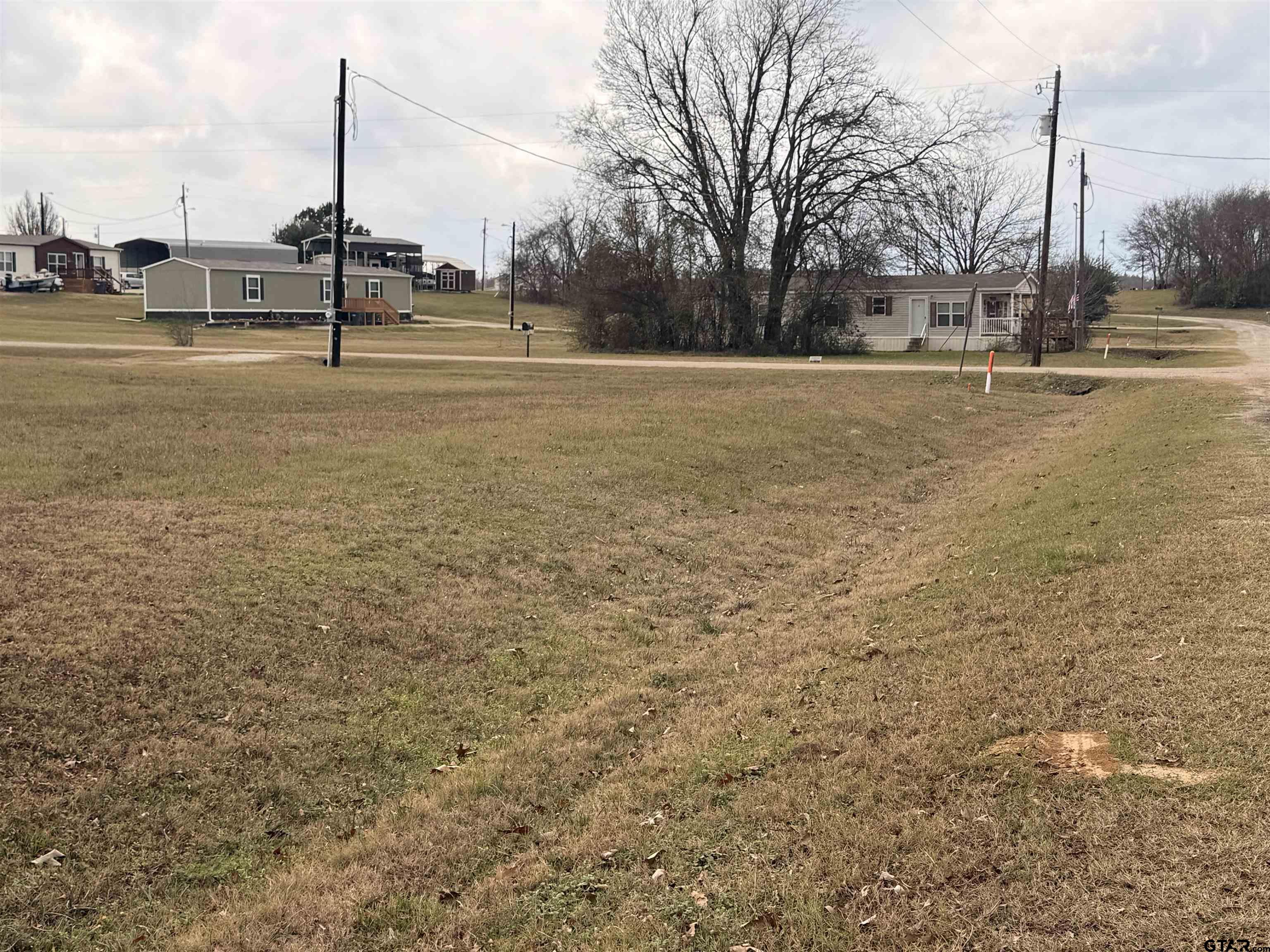 0 Waterfront Row, Unit 213 Quitman, TX 75783 - Photo 19 of 24 a view of a lake with houses