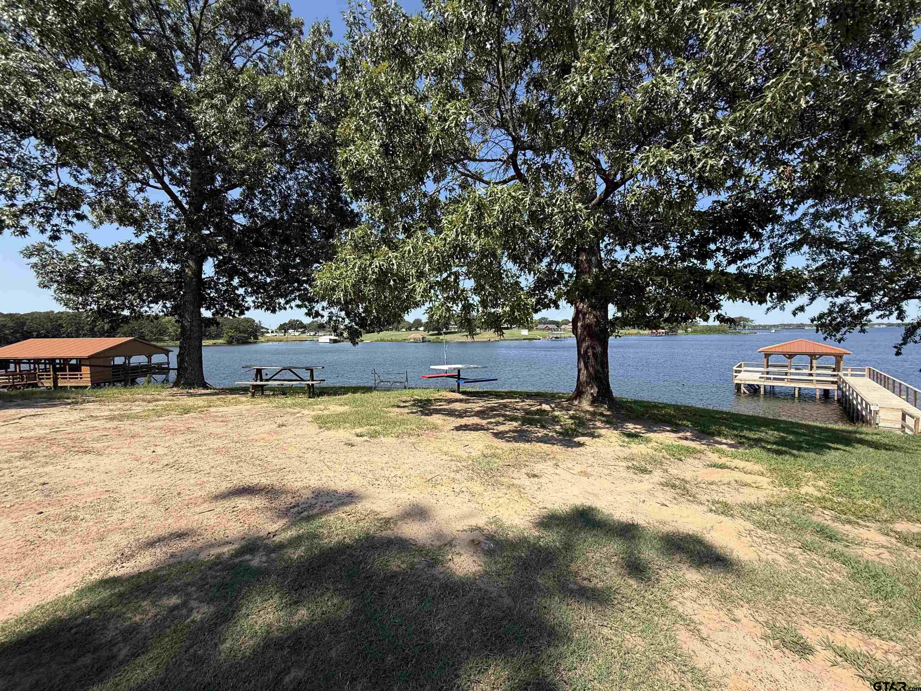0 Waterfront Row, Unit 213 Quitman, TX 75783 - Photo 6 of 24 a backyard of a house with trees and houses