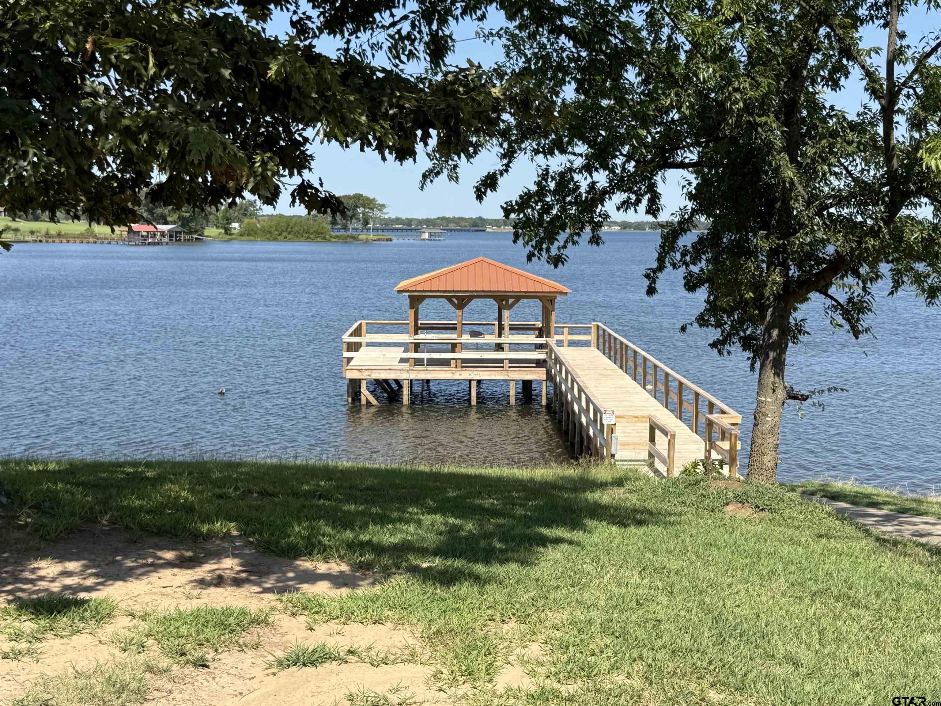 0 Waterfront Row, Unit 213 Quitman, TX 75783 - Photo 7 of 24 a backyard of a house with table and chairs