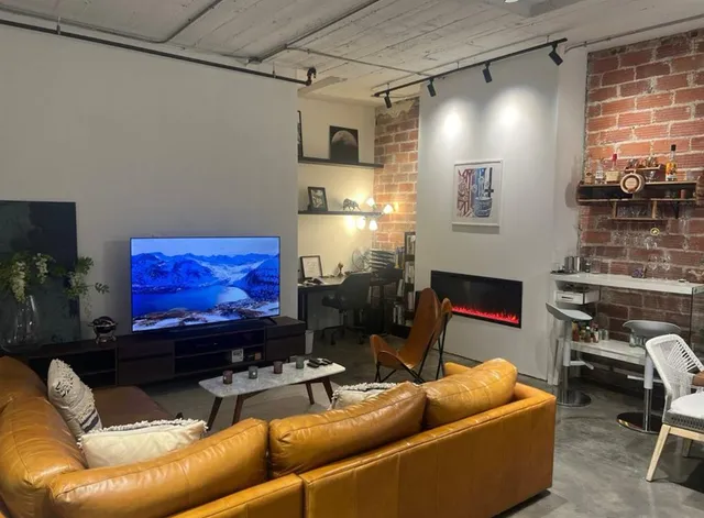 a living room with furniture a fireplace and a flat screen tv