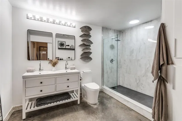 a bathroom with a sink toilet a mirror and shower