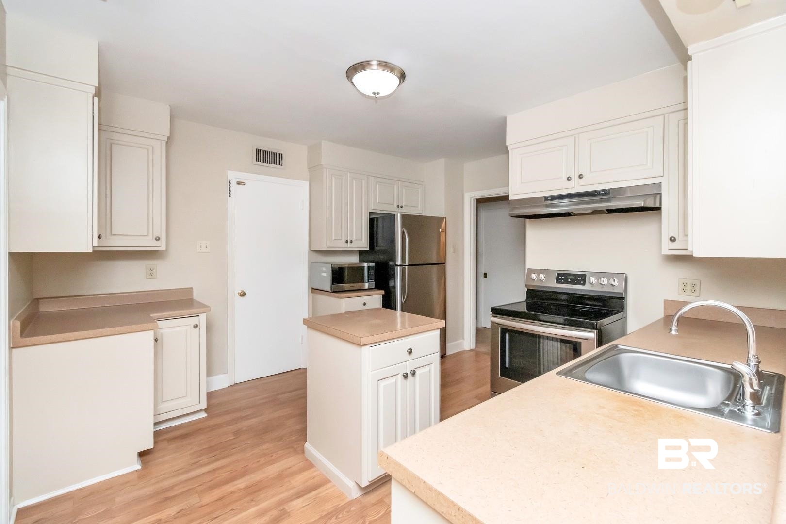 308 Brawood Drive Mobile, AL 36608 - Photo 12 of 33 Kitchen with light wood-type flooring, stainless steel appliances, white cabinetry, and sink
