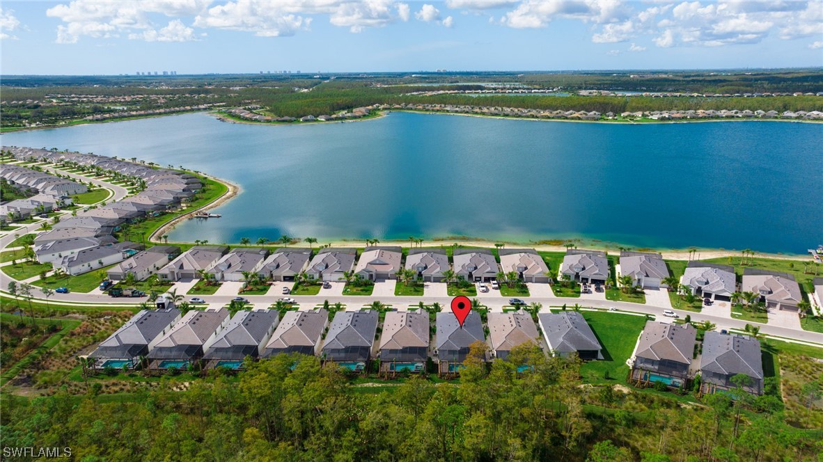 an aerial view of a houses with outdoor space and a lake view