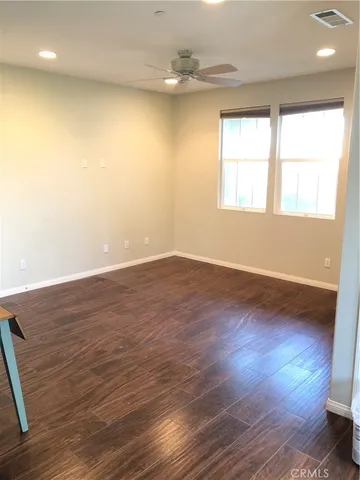 a view of a hallway with wooden floor and closet