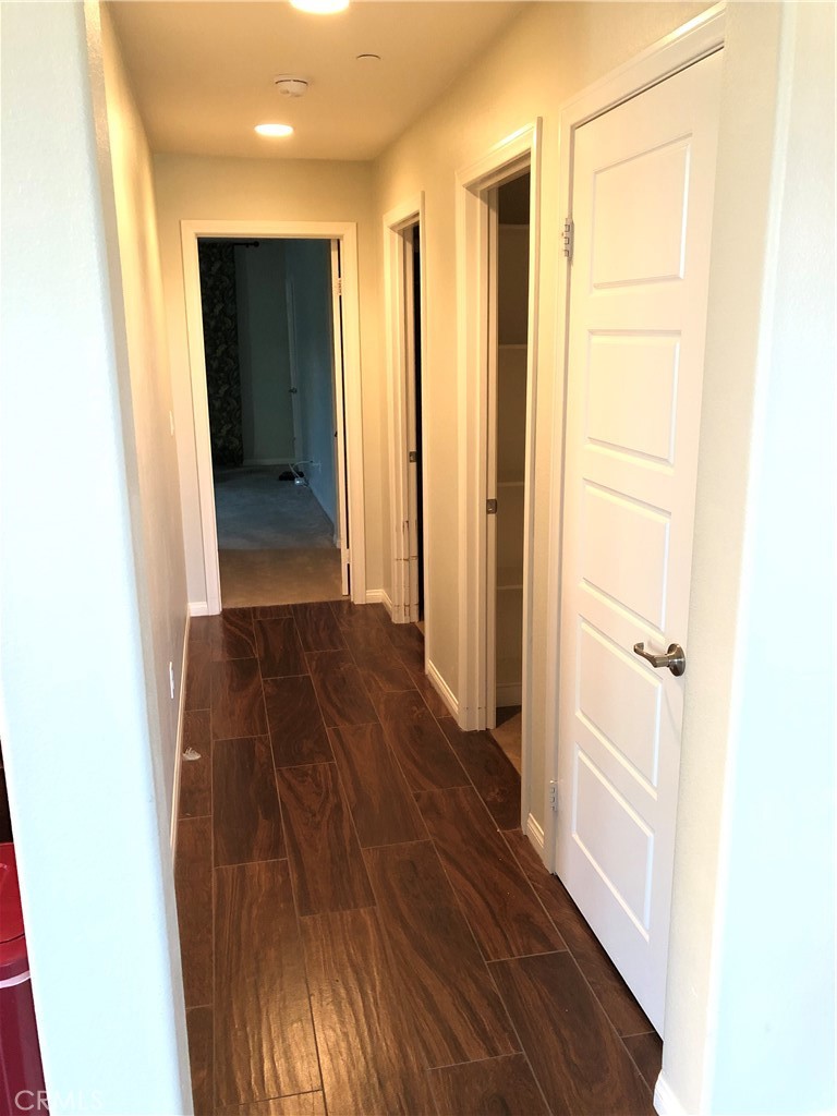 41299 St Croix Temecula, CA 92591 - Photo 12 of 17 a view of a hallway with wooden floor and closet