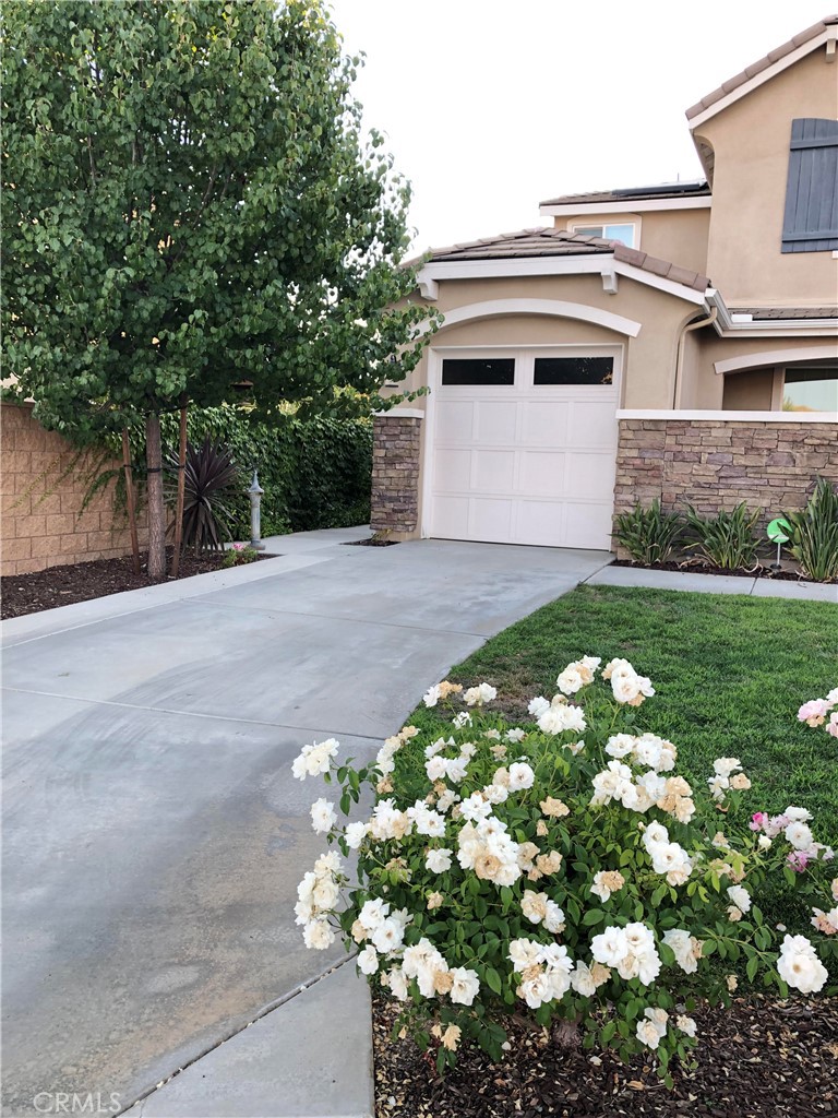 41299 St Croix Temecula, CA 92591 - Photo 16 of 17 a white house with a small yard and large trees