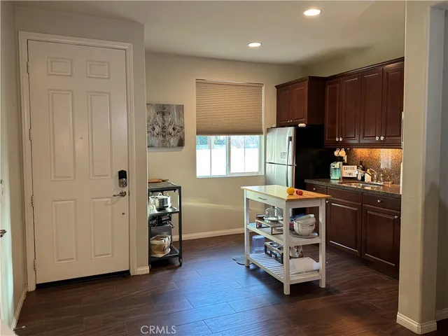 a kitchen with stainless steel appliances a stove a refrigerator and a microwave