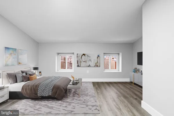 a spacious bedroom with a bed and a couch