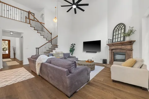 a living room with furniture a flat screen tv and a fireplace