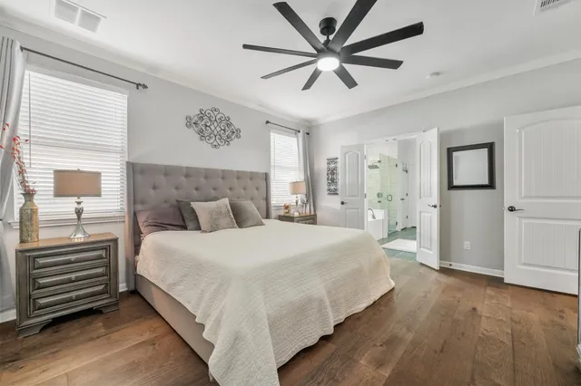 a bedroom with a large bed and a chandelier