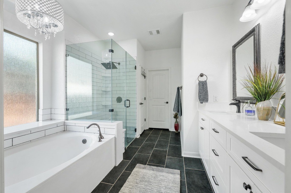 12404 Mediterra Place Austin, TX 78732 - Photo 21 of 39 a bathroom with a tub sink and mirror