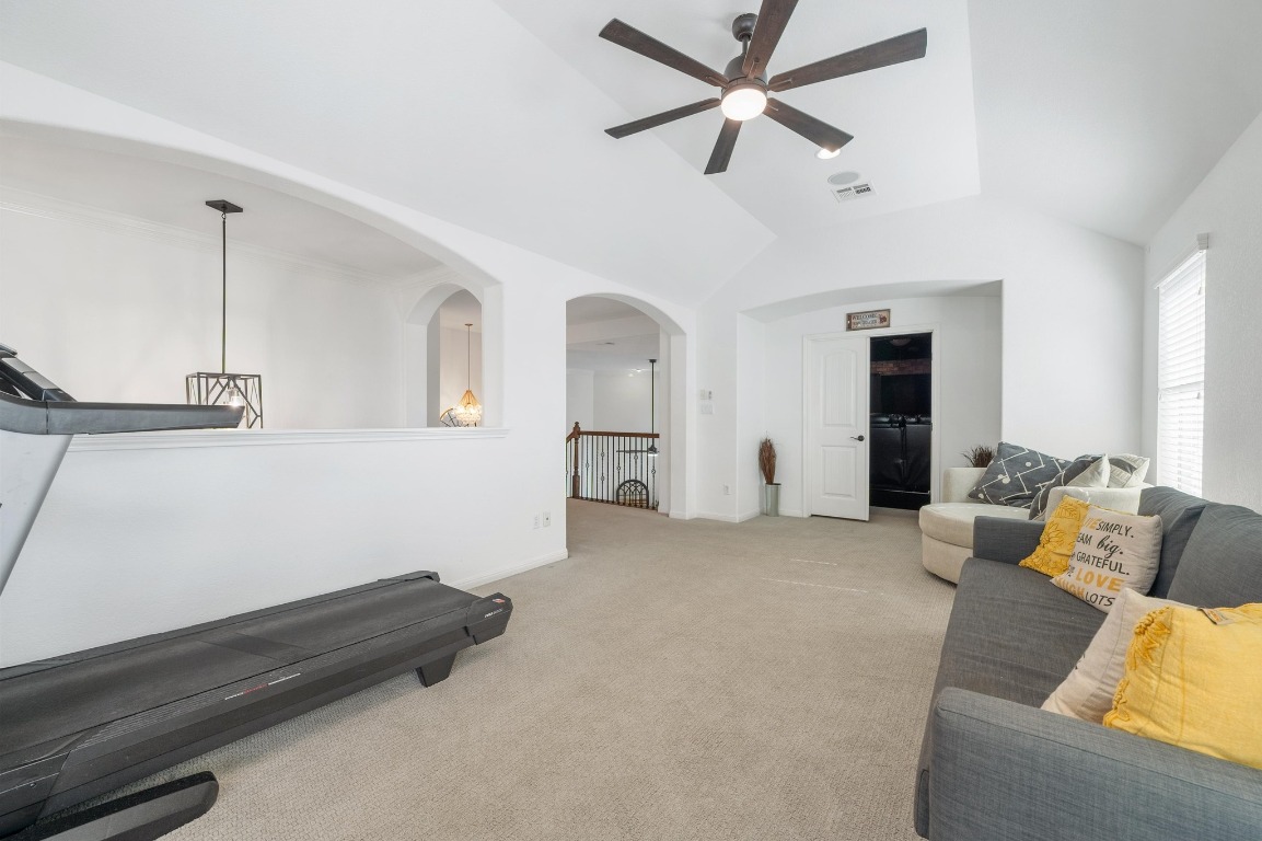 12404 Mediterra Place Austin, TX 78732 - Photo 26 of 39 a living room with furniture and a ceiling fan