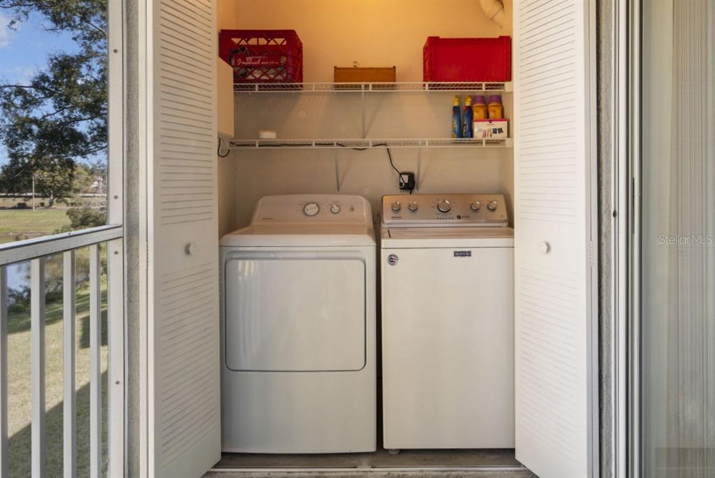 1438 Millstream Lane, Unit 203 Dunedin, FL 34698 - Photo 17 of 60 a utility room with dryer and washer