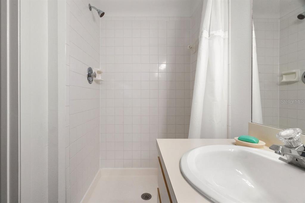 1438 Millstream Lane, Unit 203 Dunedin, FL 34698 - Photo 21 of 60 a bathroom with a tub and sink